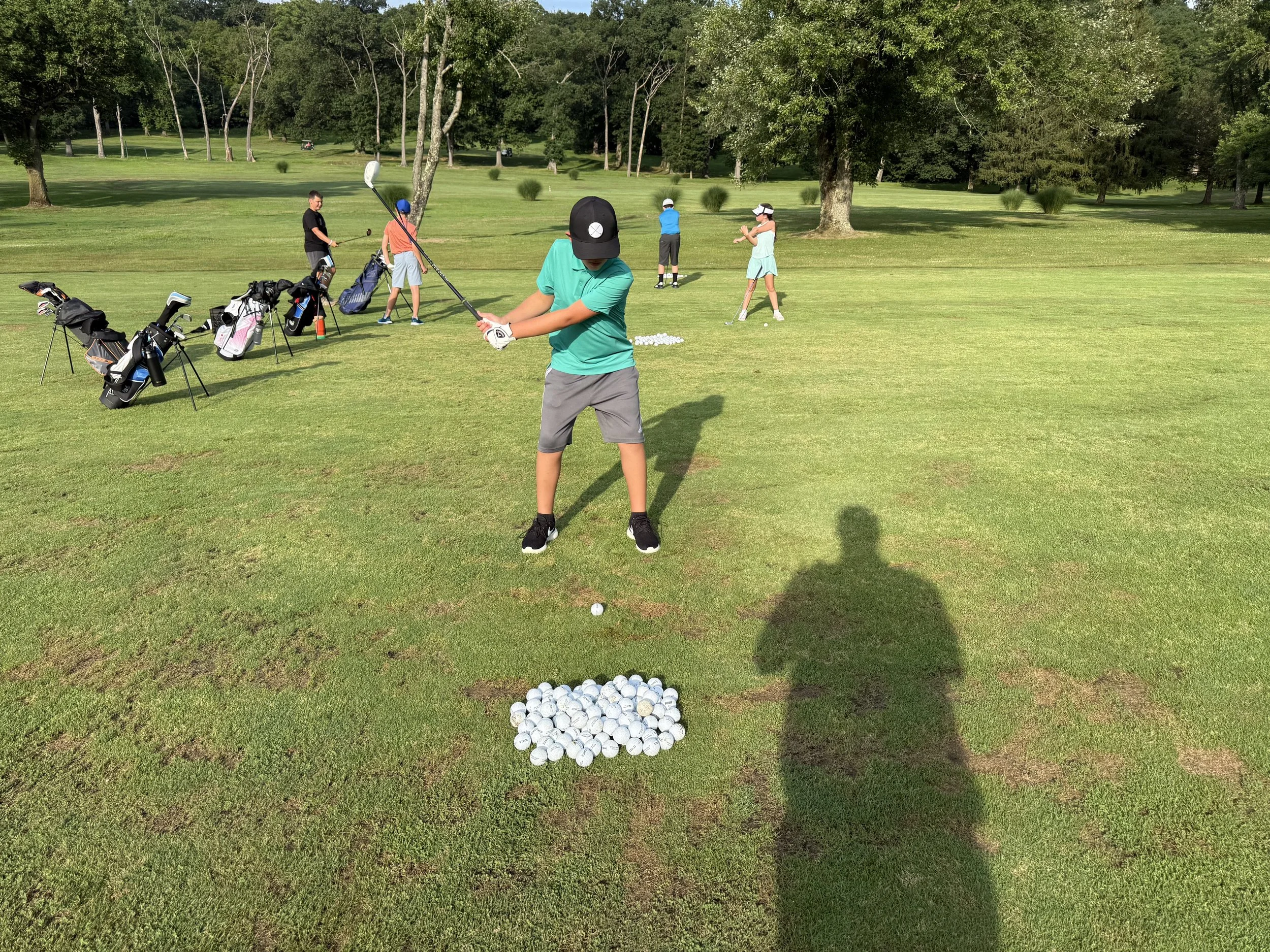 Junior Golfer Practicing shots on the fairway