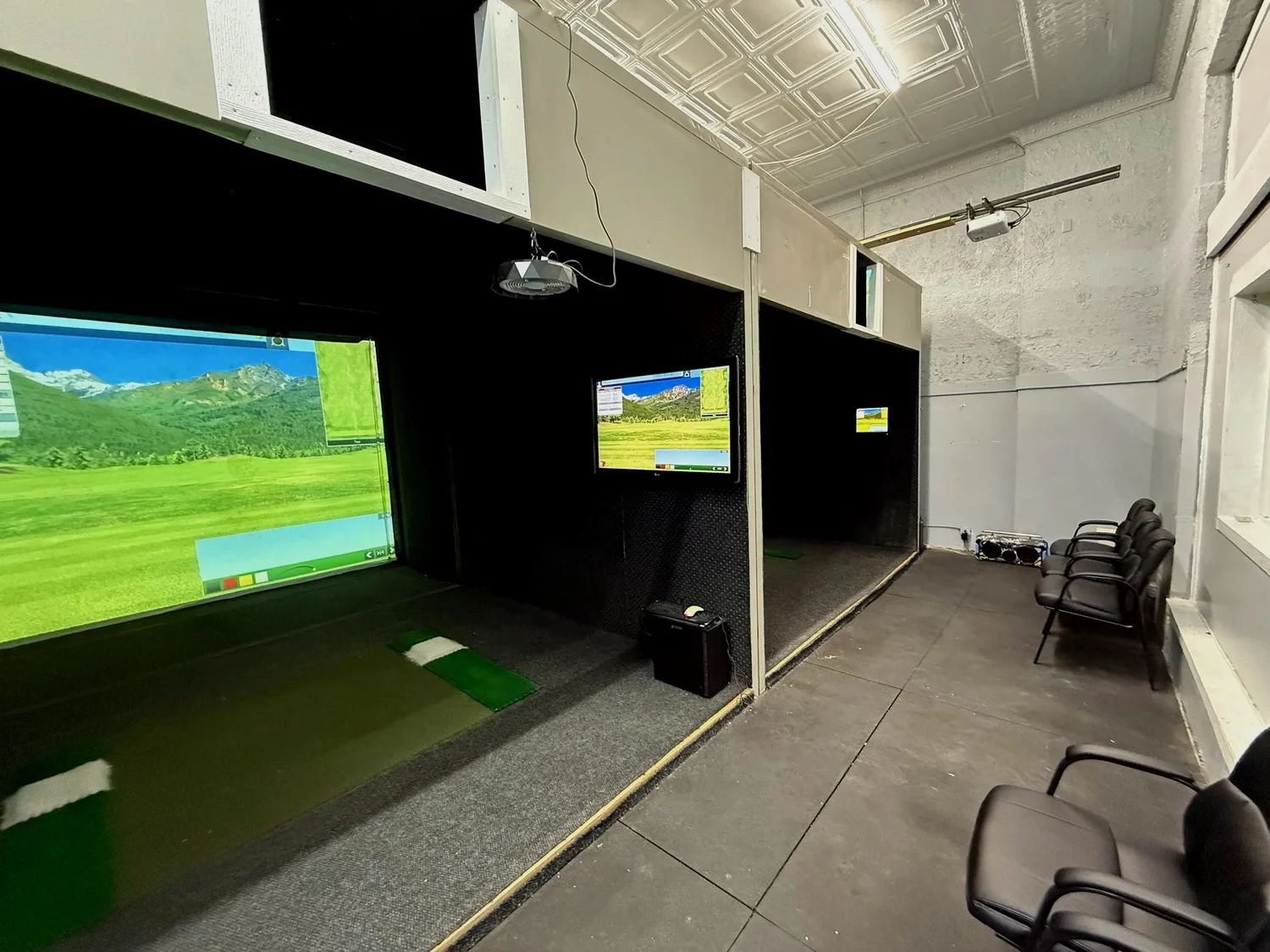Two indoor golf simulator bays at Swing Zone
