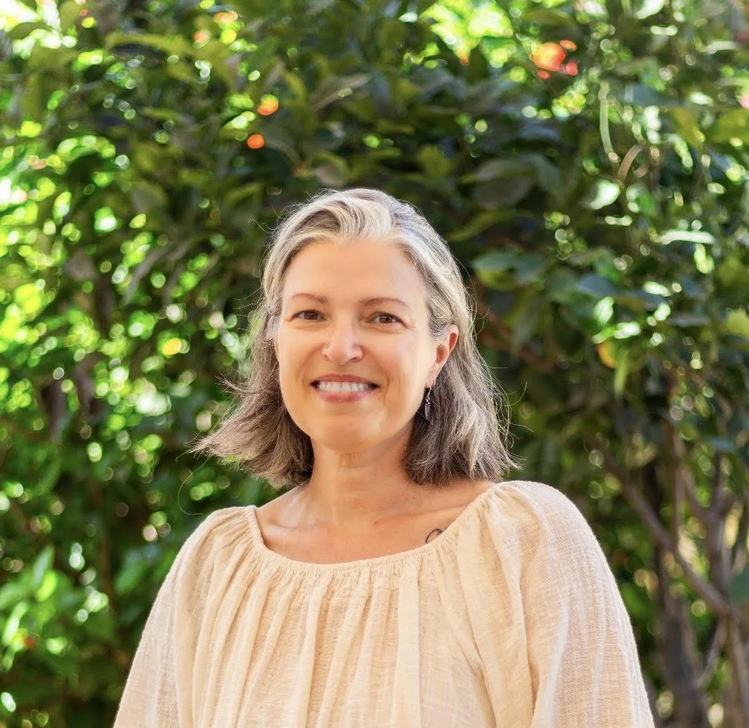 Beatrice, Yin Yoga and energy healing facilitator at Samudra Retreats, practicing gentle embodiment inside the stone sanctuary