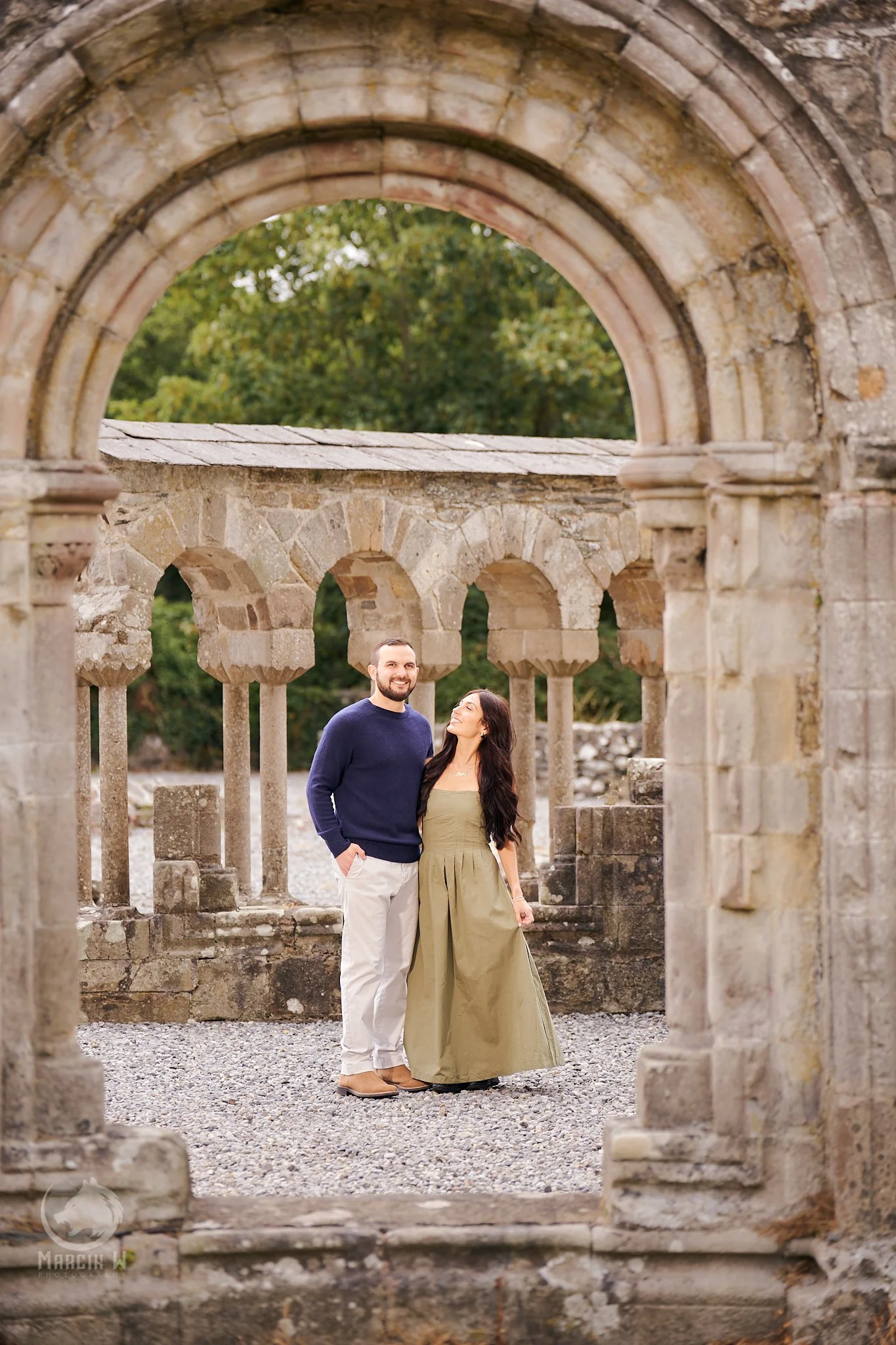 American couple celebrating their engagement in Ireland with a romantic portrait session at historic landmarks in County Louth, photographed by Marcin W Photography.