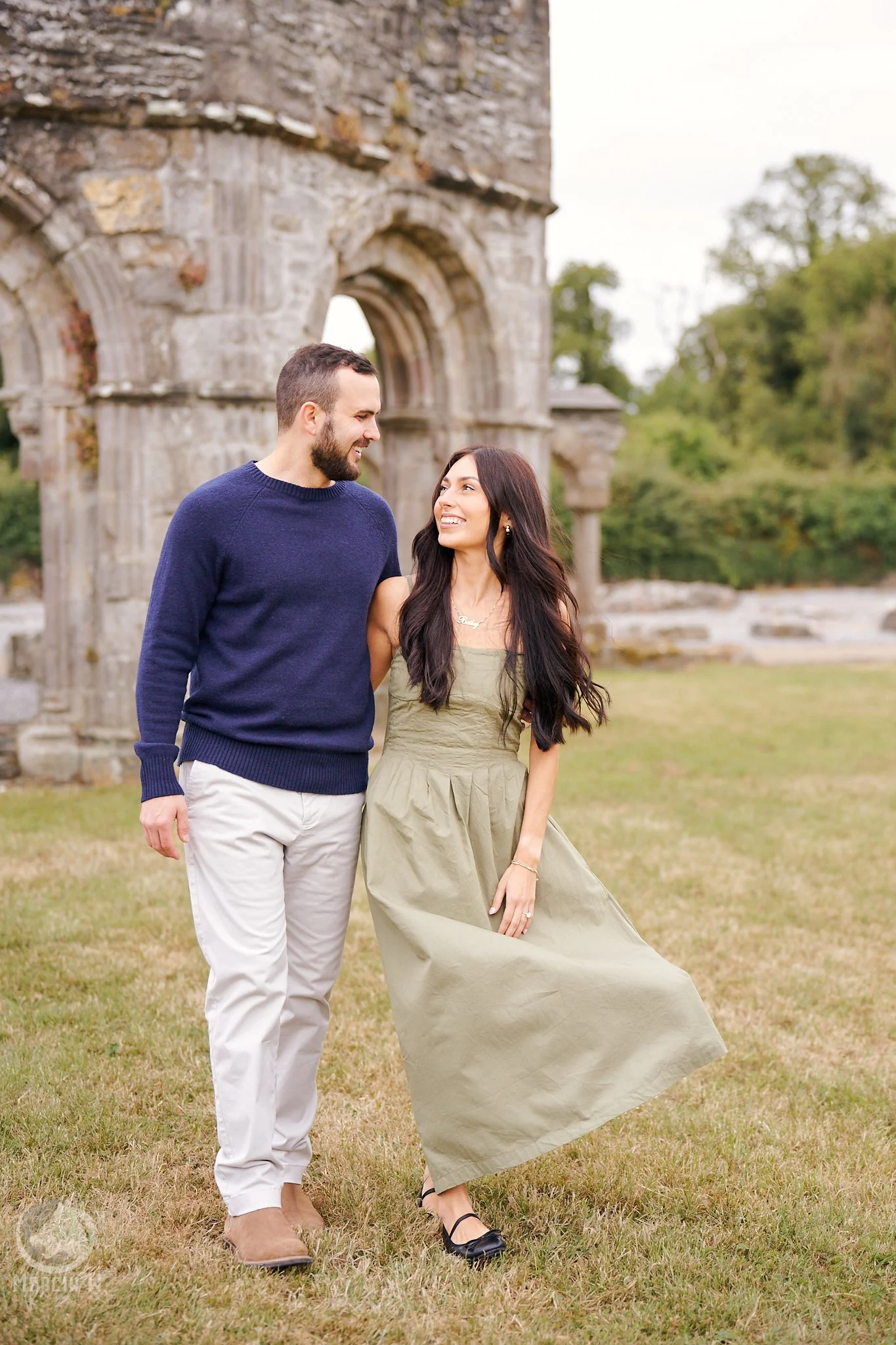 Keegan and Bailey sharing a romantic moment among the historic ruins of Mellifont Abbey, County Louth, Ireland, during their engagement photography session.