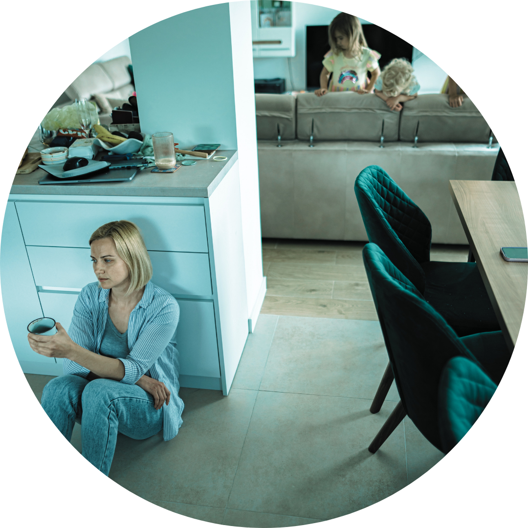 Mother mentally tired drinking coffee sitting on the floor