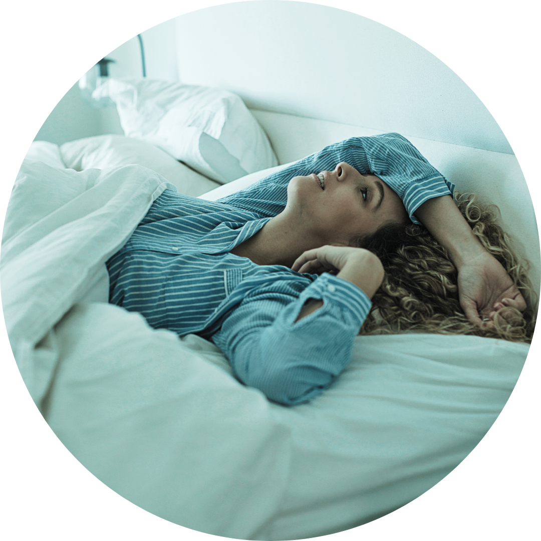 A woman-mother with arm over face in bed restless sleep