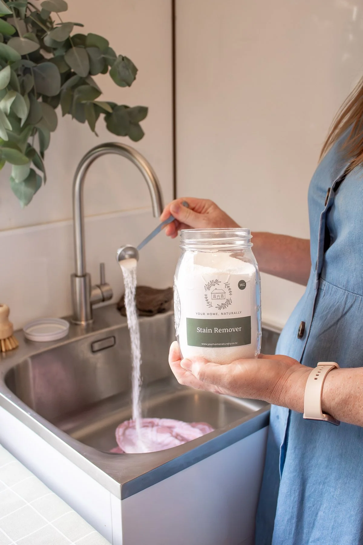 Using Stain Remover to soak stained items in sink |