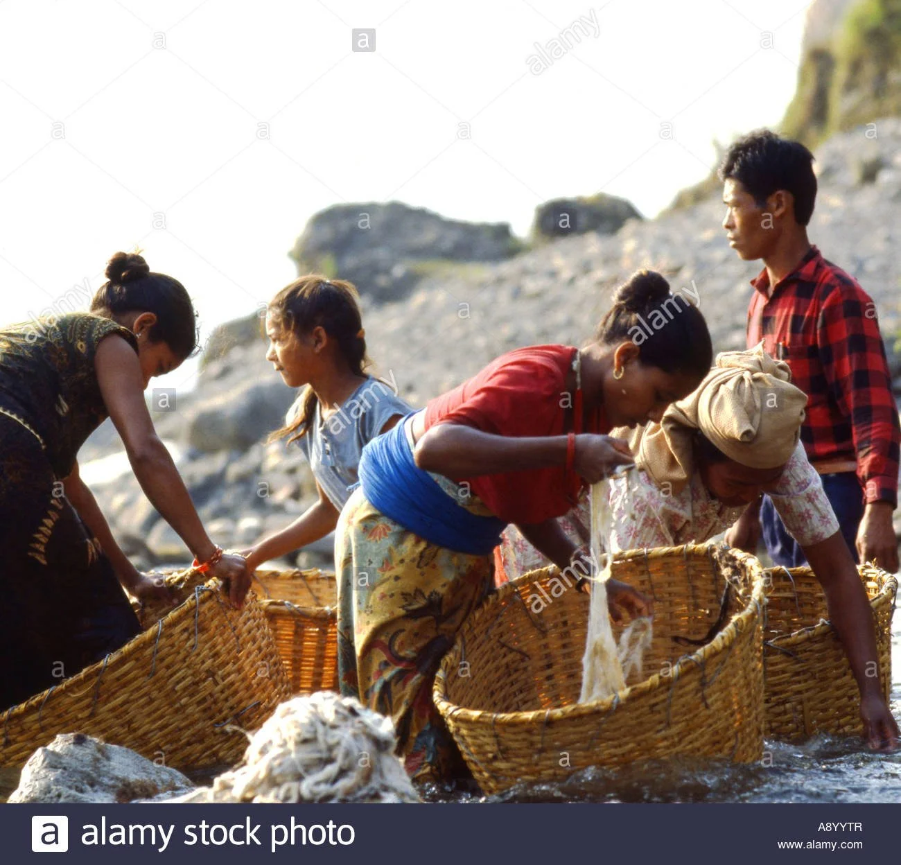 nepalese-women-washing-wool-in-river-near-pokhara-nepal-A8YYTR.jpg