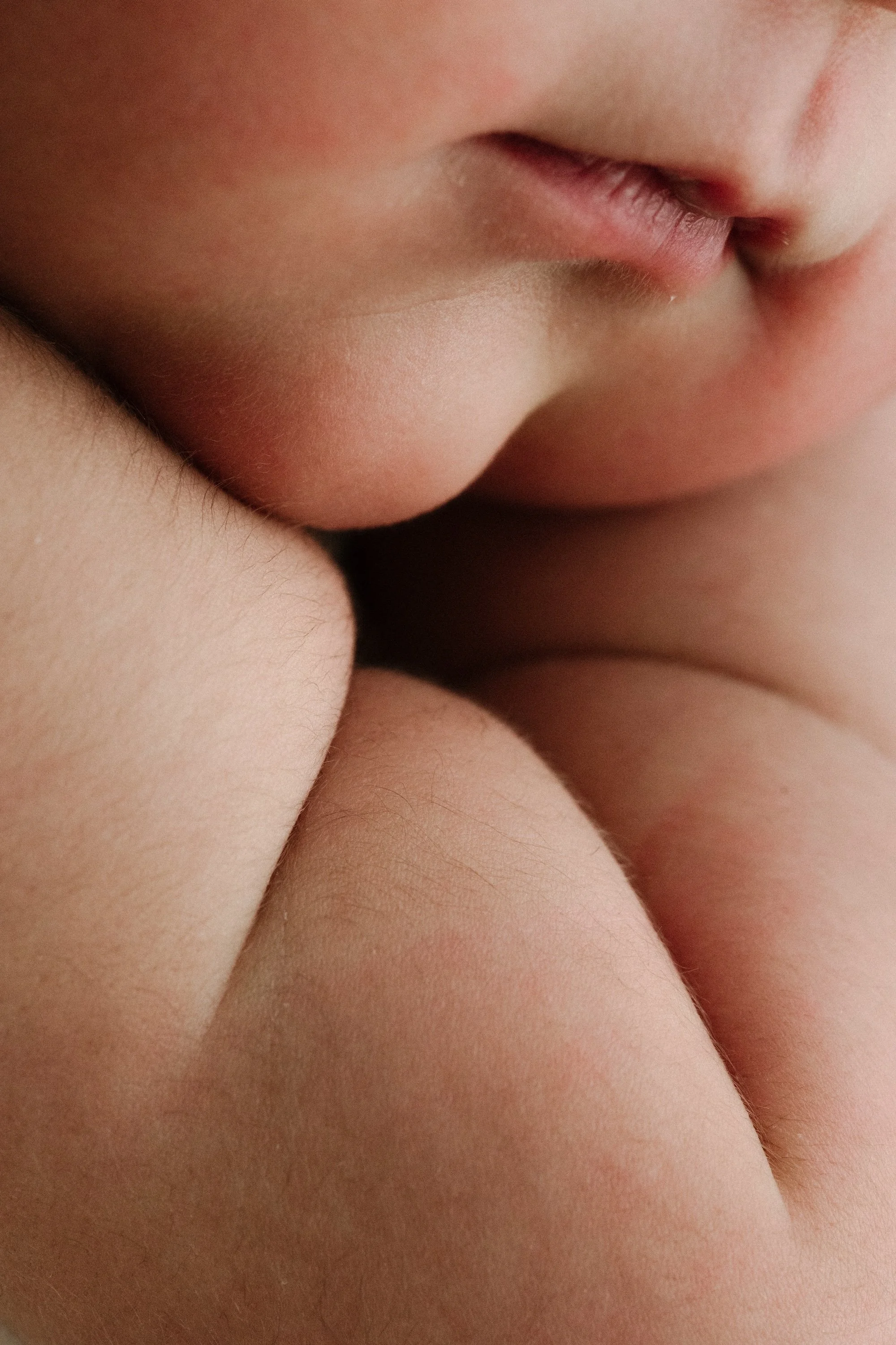 Baby details during photoshoot in a timeless white setting