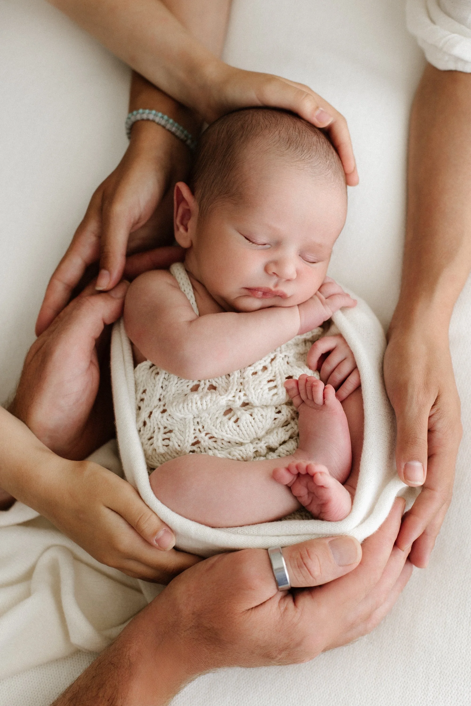 Baby newborn during photoshoot in a timeless white setting