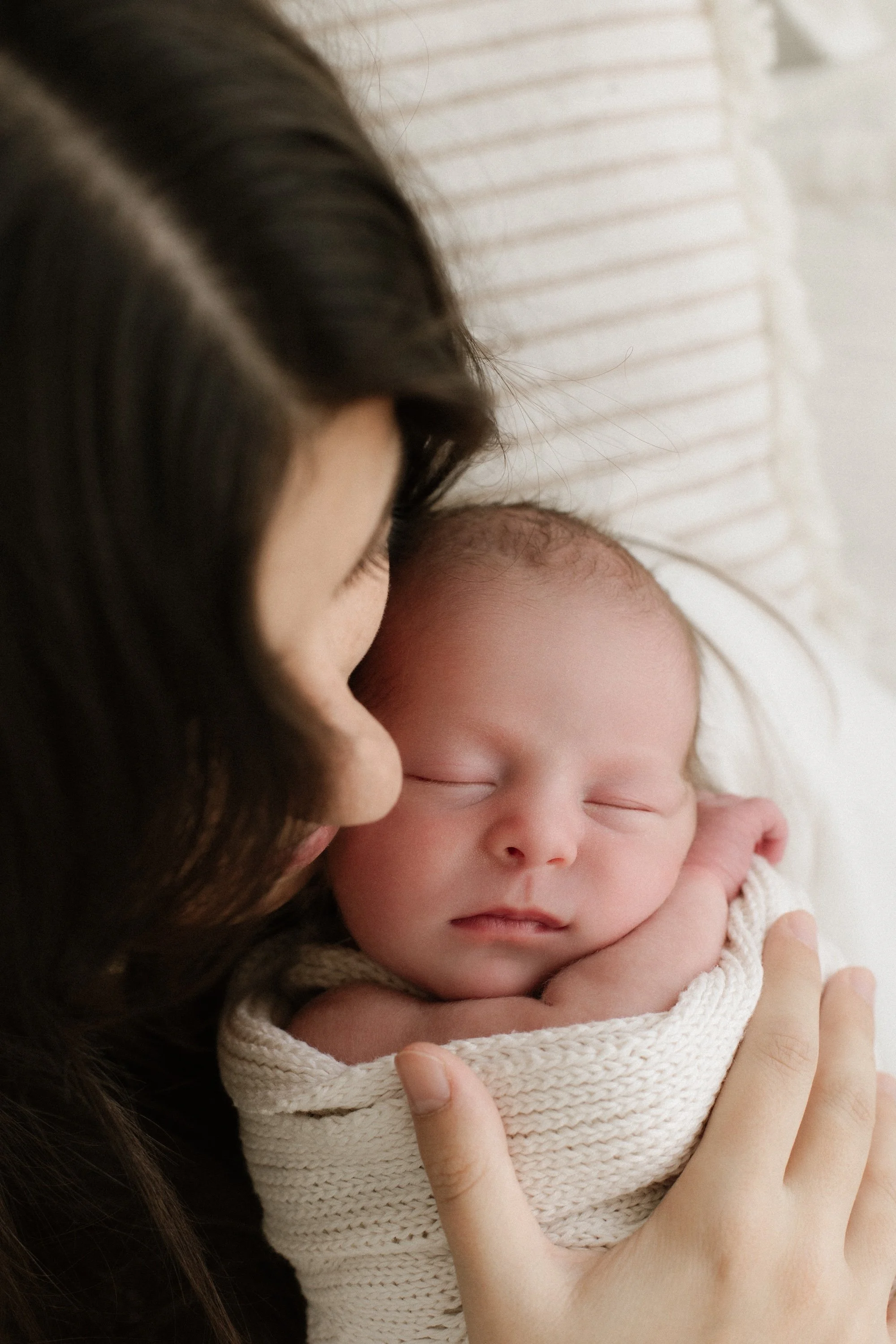 Mum kissing baby during photo session