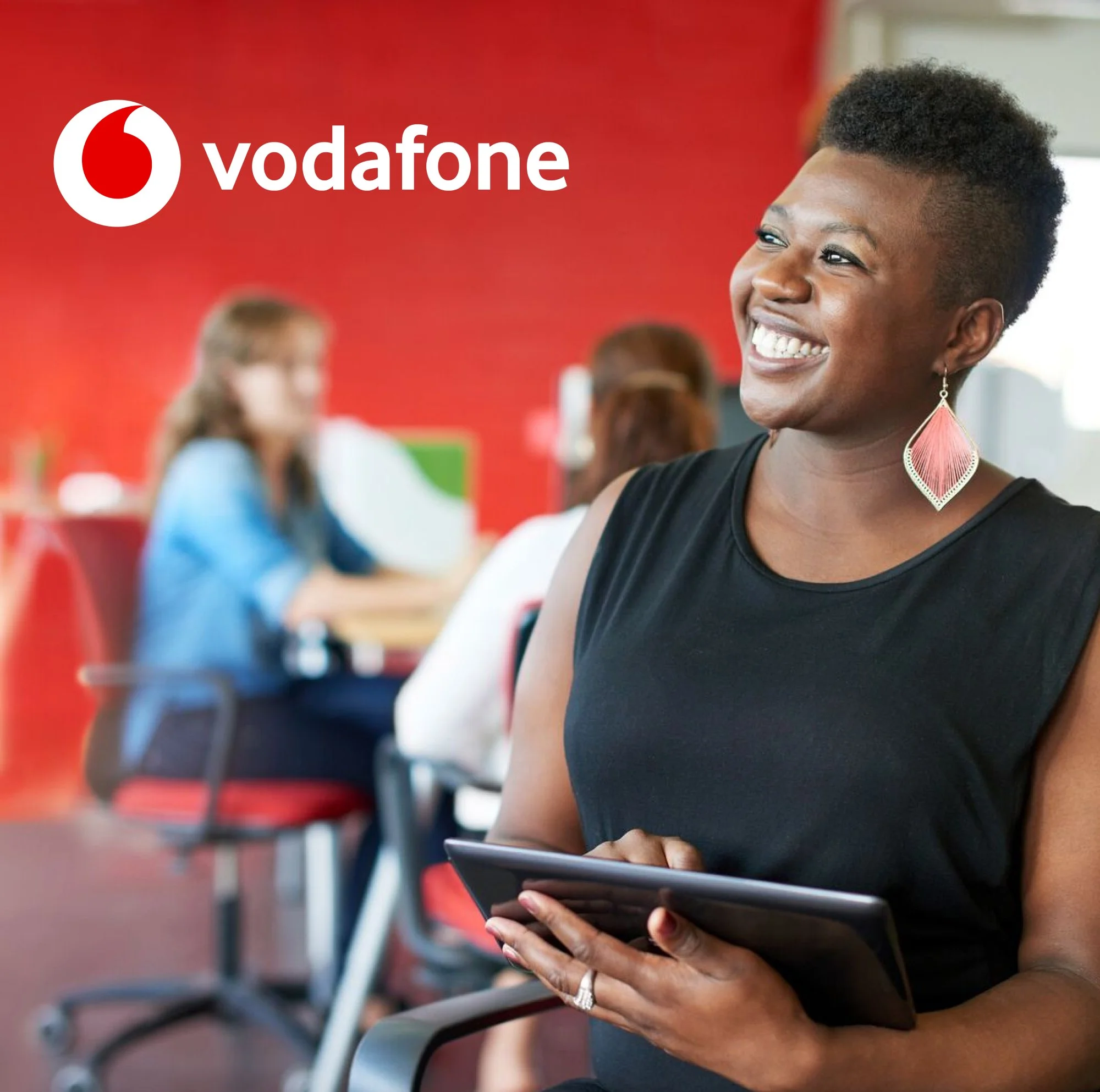 Vodafone logo overlaying an image of a young professional person in an office environment