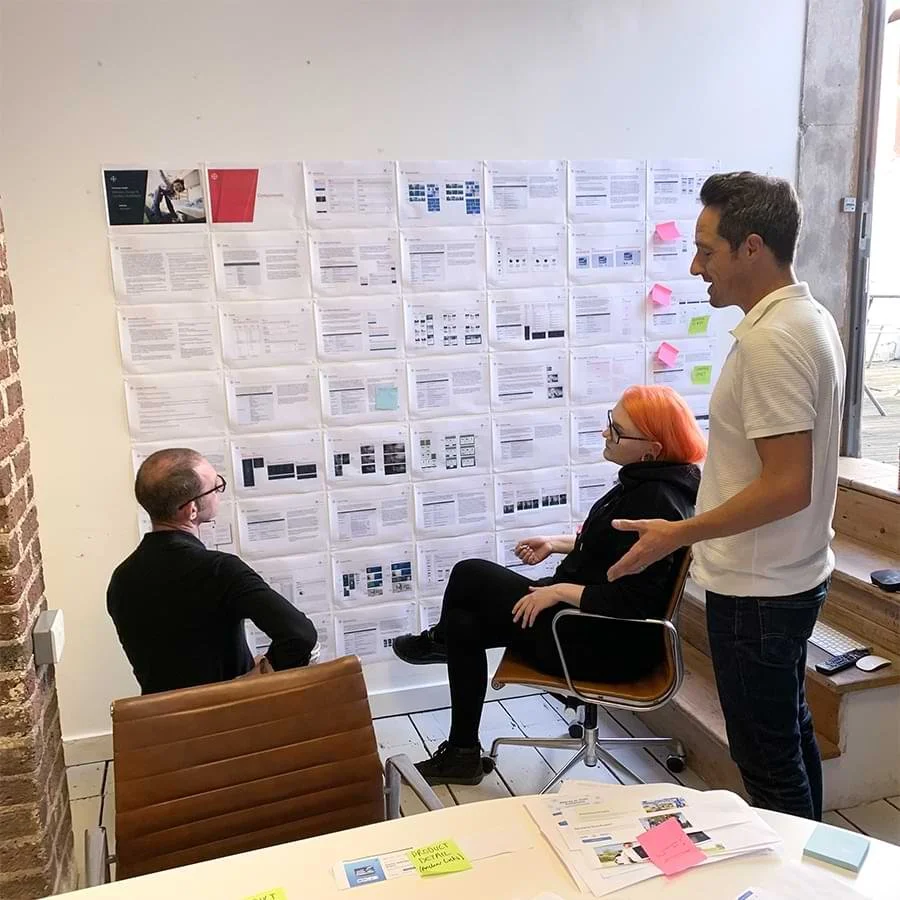Design team looking at UI patterns on a wall