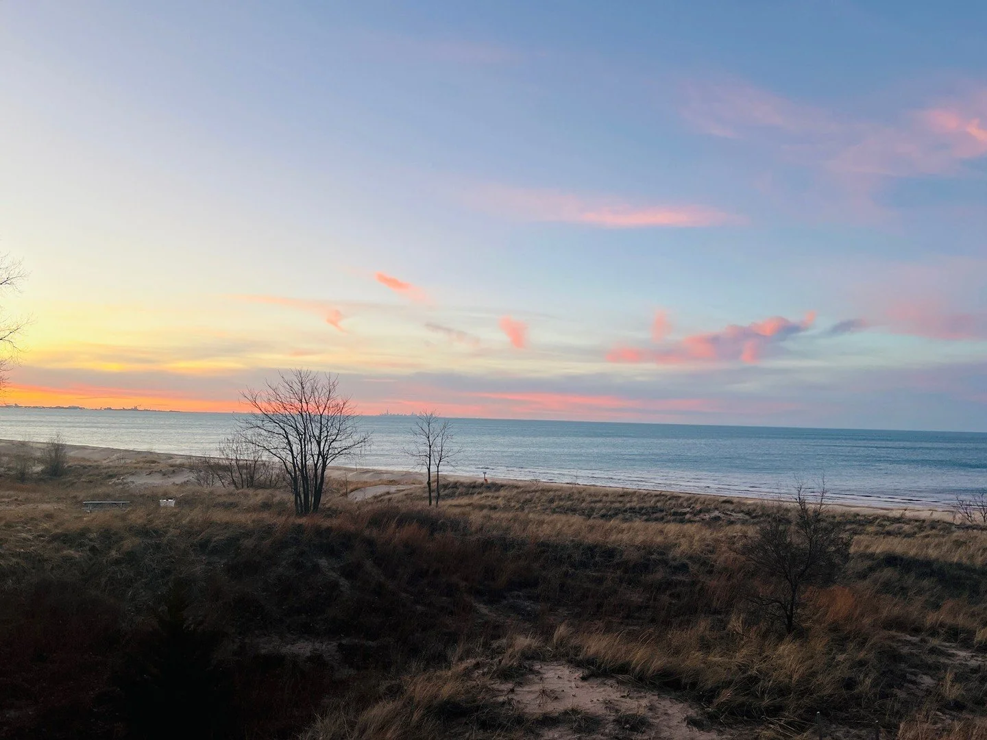 Pretty pink puffs of clouds hanging over Lake Michigan tonight, painting the sky with soft color and a hopeful glow. With the Chicago skyline shimmering on the horizon, moments like this remind us how lucky we are to call Miller Beach home. 🌅💗
.
.
