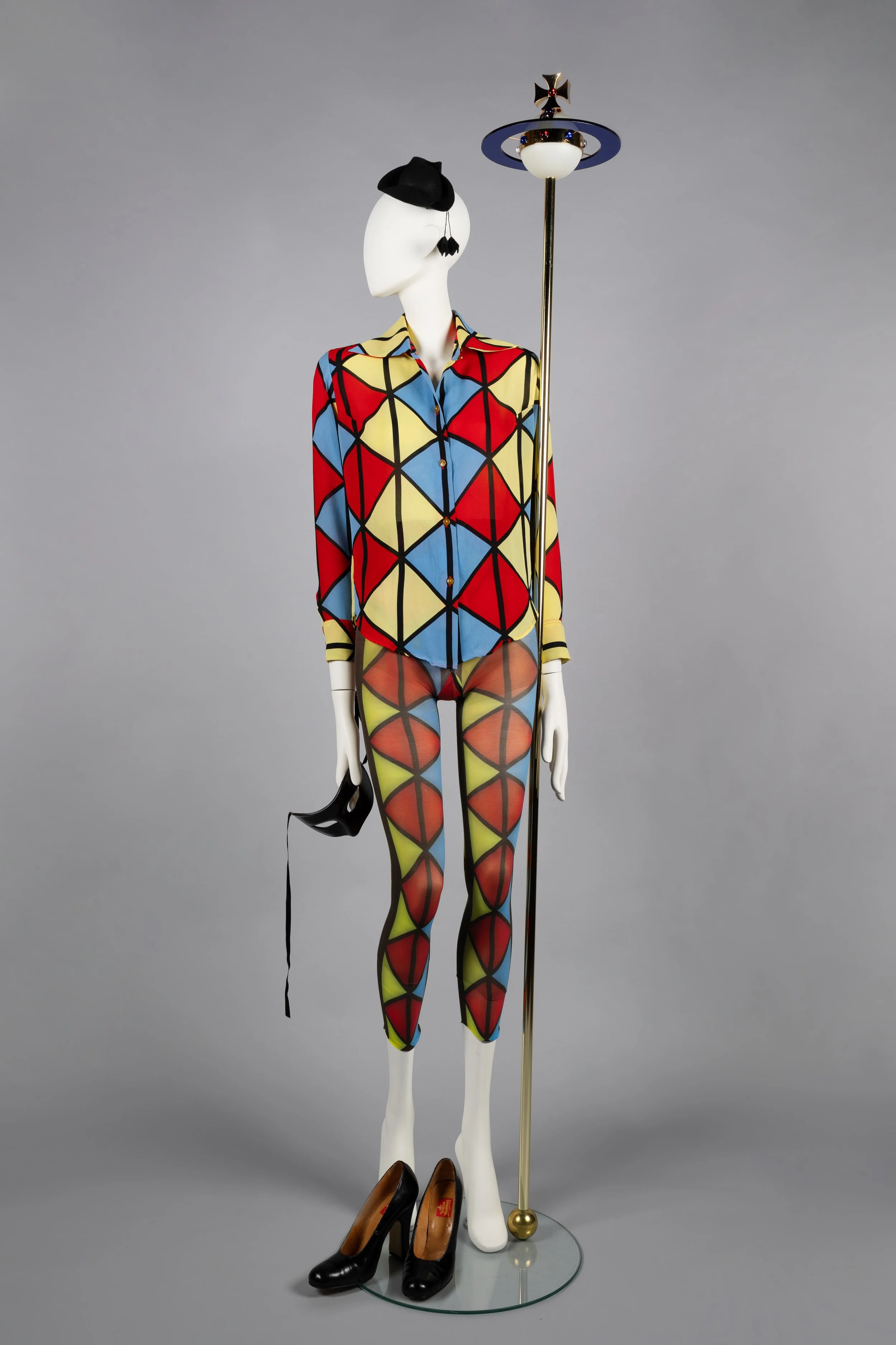 Harlequin print blouse with matching tights, mini tricorn hat, masquerade mask, patent shoes and orb sceptre   Voyage to Cythera, AW 1989-90.jpg