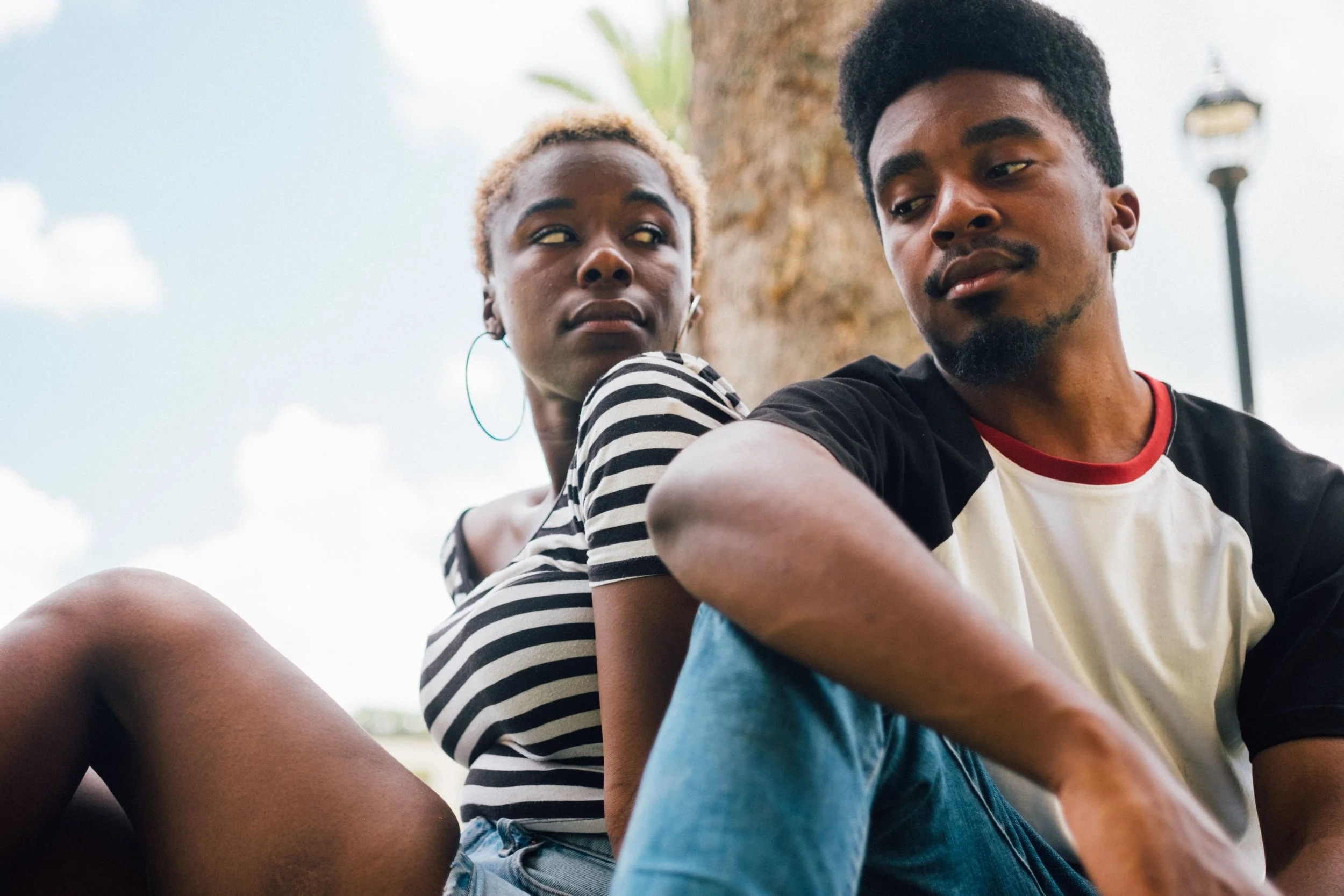 Married couple sitting separately in their home, representing quiet divorce, relationship burnout, and emotional disconnection.