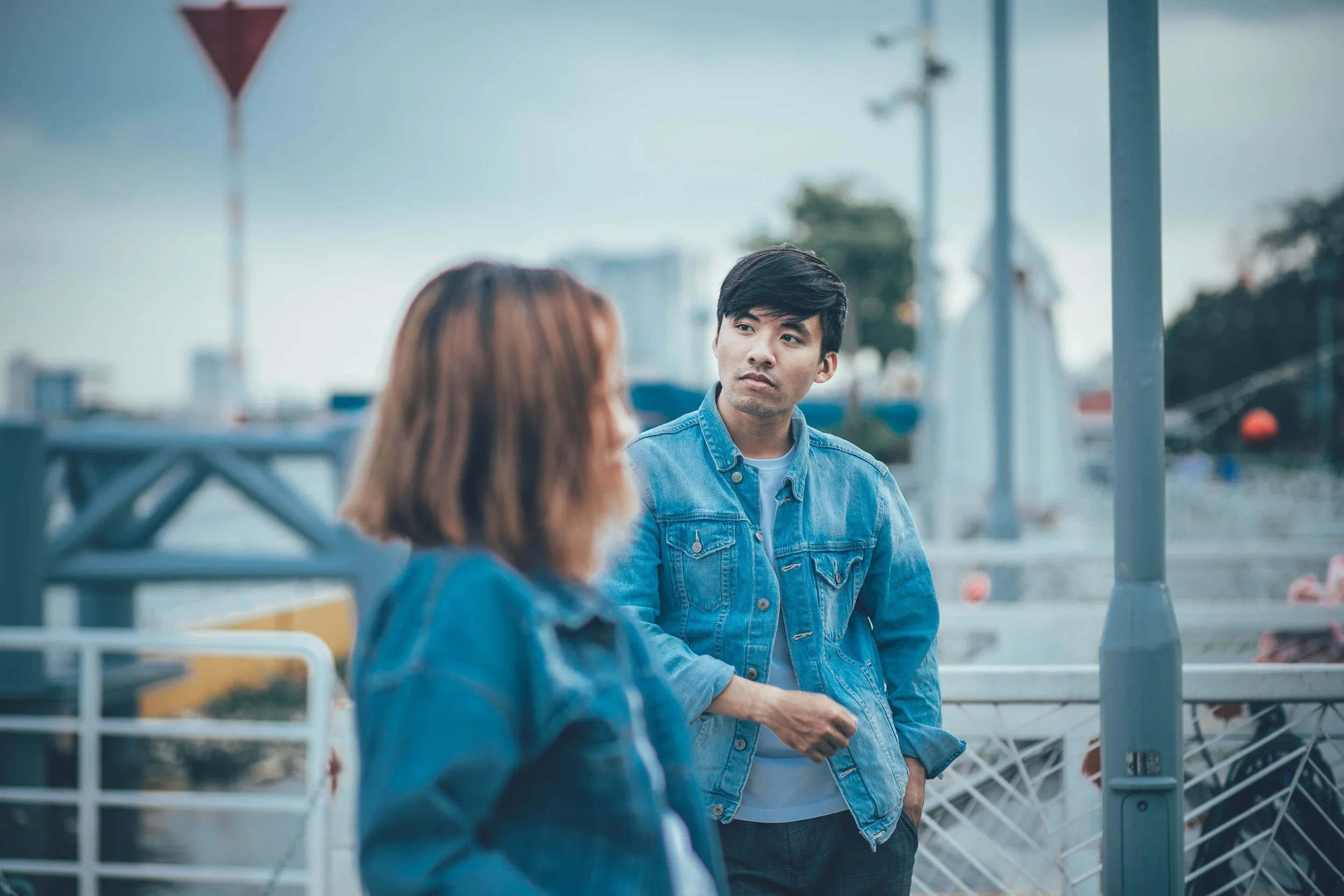 Partners sitting together but appearing emotionally distant, illustrating relationship burnout and a loss of emotional connection.