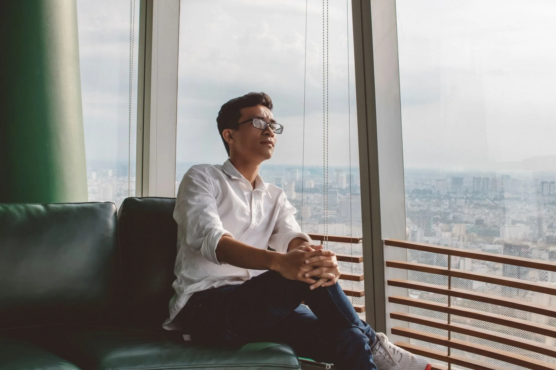 person sitting by window thinking if its time to start a depression treatment