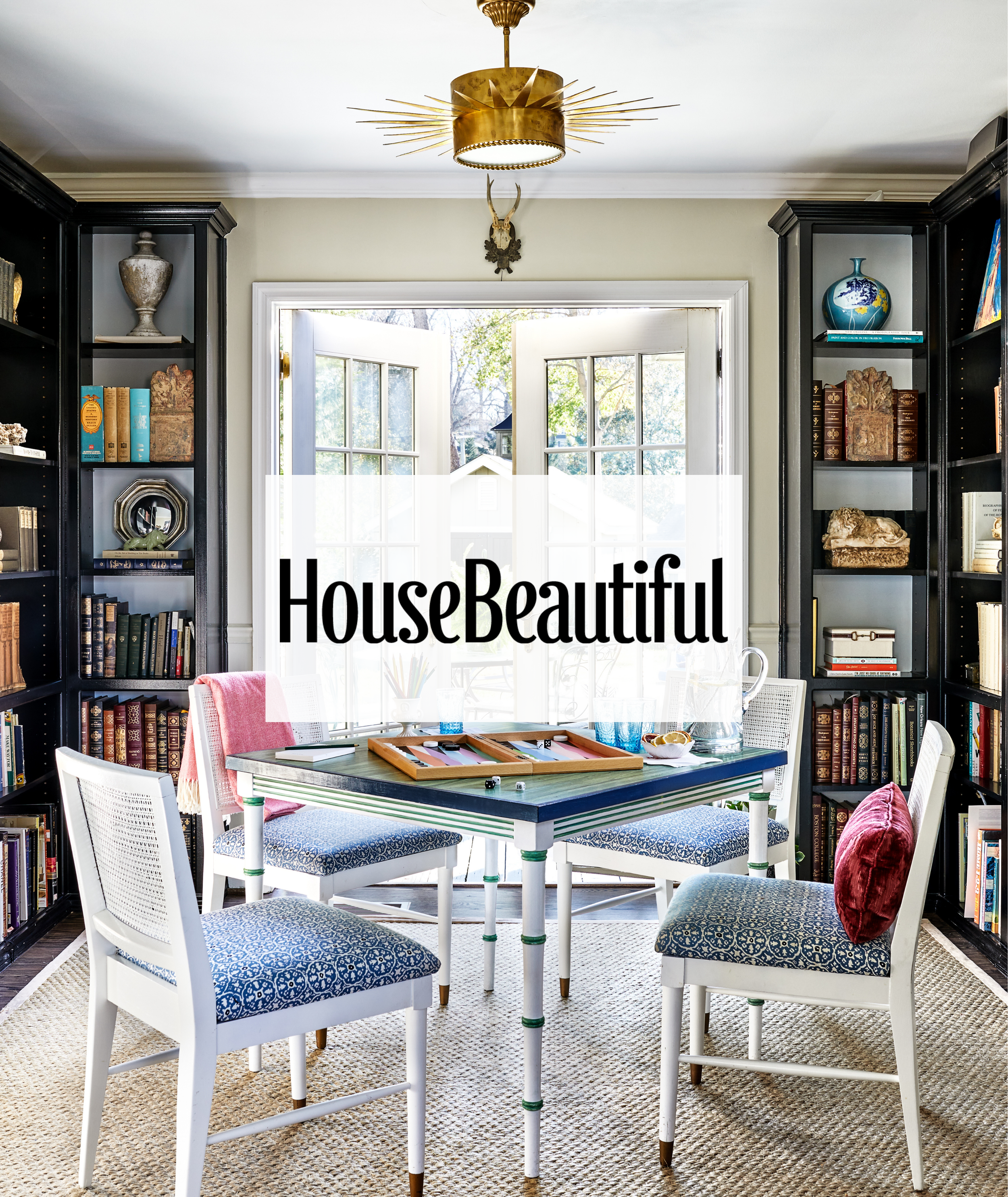 A game room featuring built in bookshelves and chairs covered in Marika Meyer Textiles. An overlay of the House Beautiful logo where this project was featured.