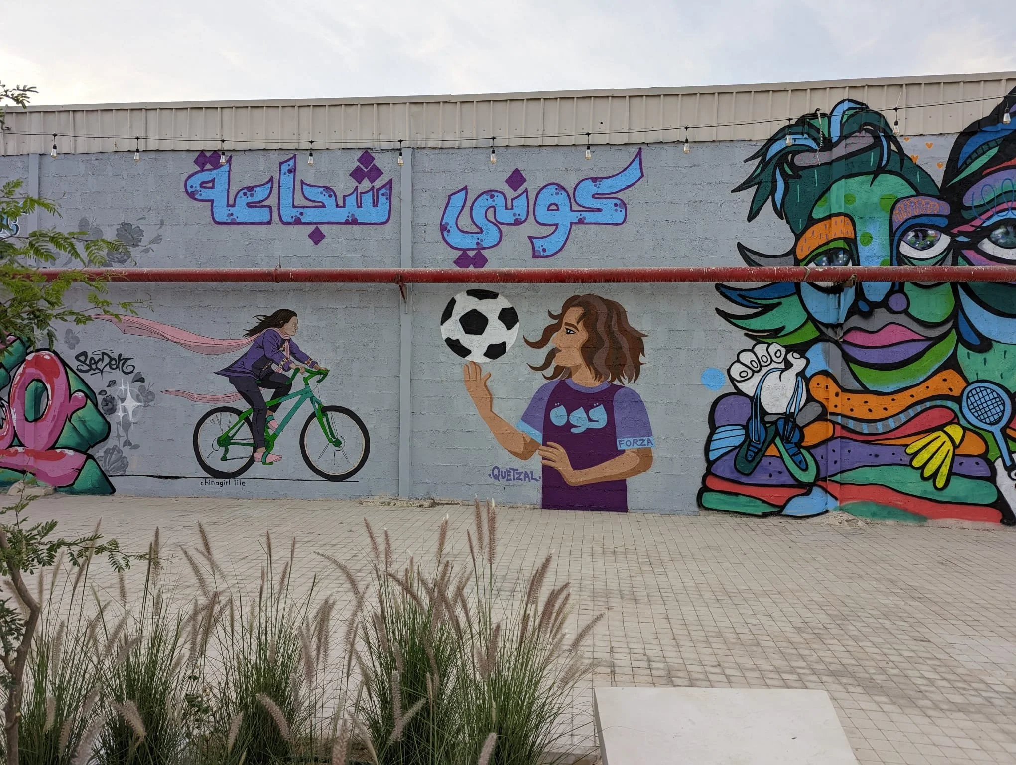 Chinagirl Tile and Calle Libre street art festival as a part of  "She (who) moves" mural project in Riyadh, Saudi Arabia, promoting women in sports and raising awareness around sports and wellbeing