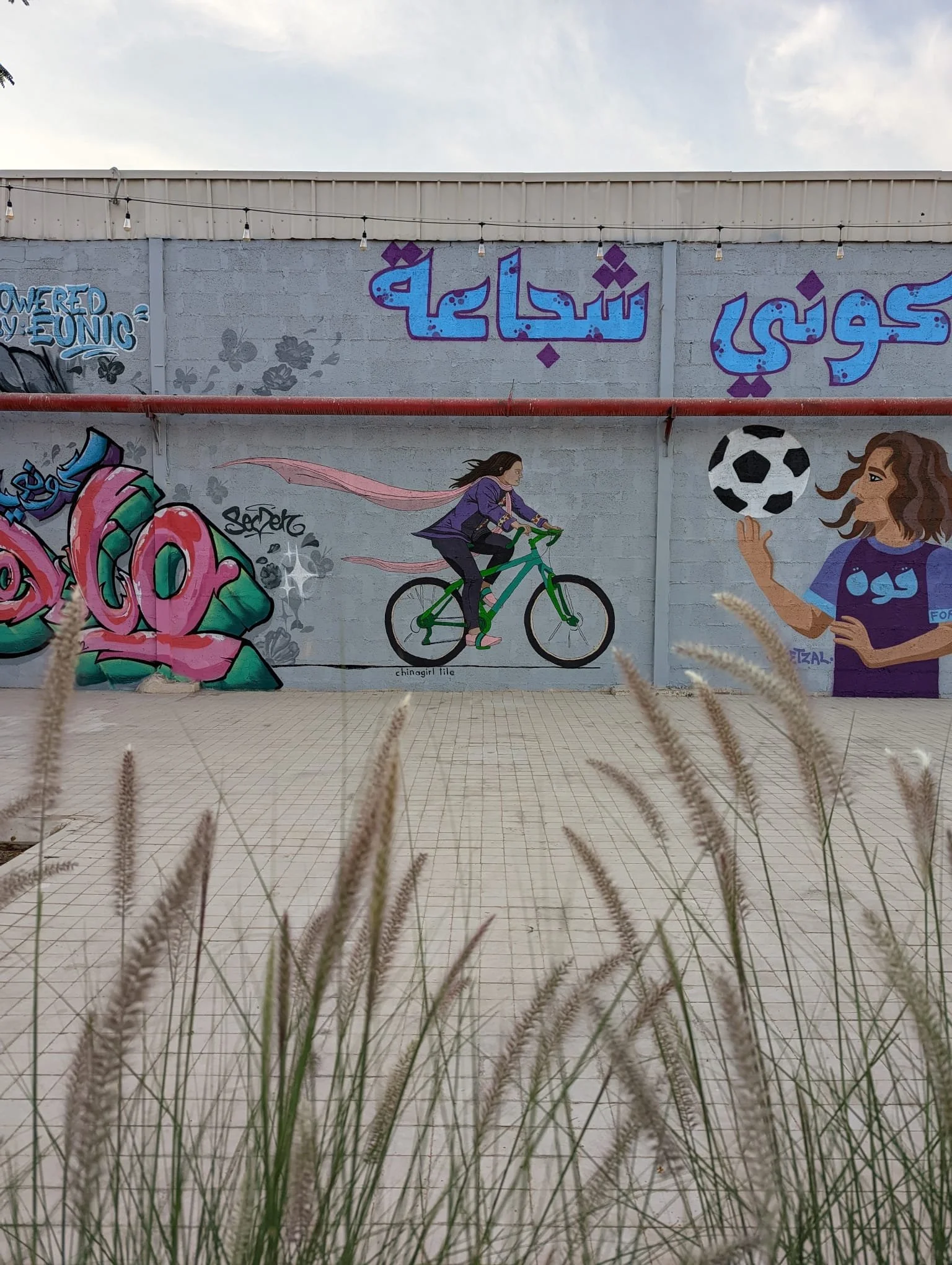 Chinagirl Tile and Calle Libre street art festival as a part of  "She (who) moves" mural project in Riyadh, Saudi Arabia, promoting women in sports and raising awareness around sports and wellbeing