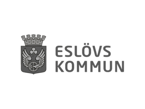 The logo of Eslöv Municipality featuring a coat of arms with a crown, a bird, and a wheel, alongside the text 'Eslöv Kommun'.