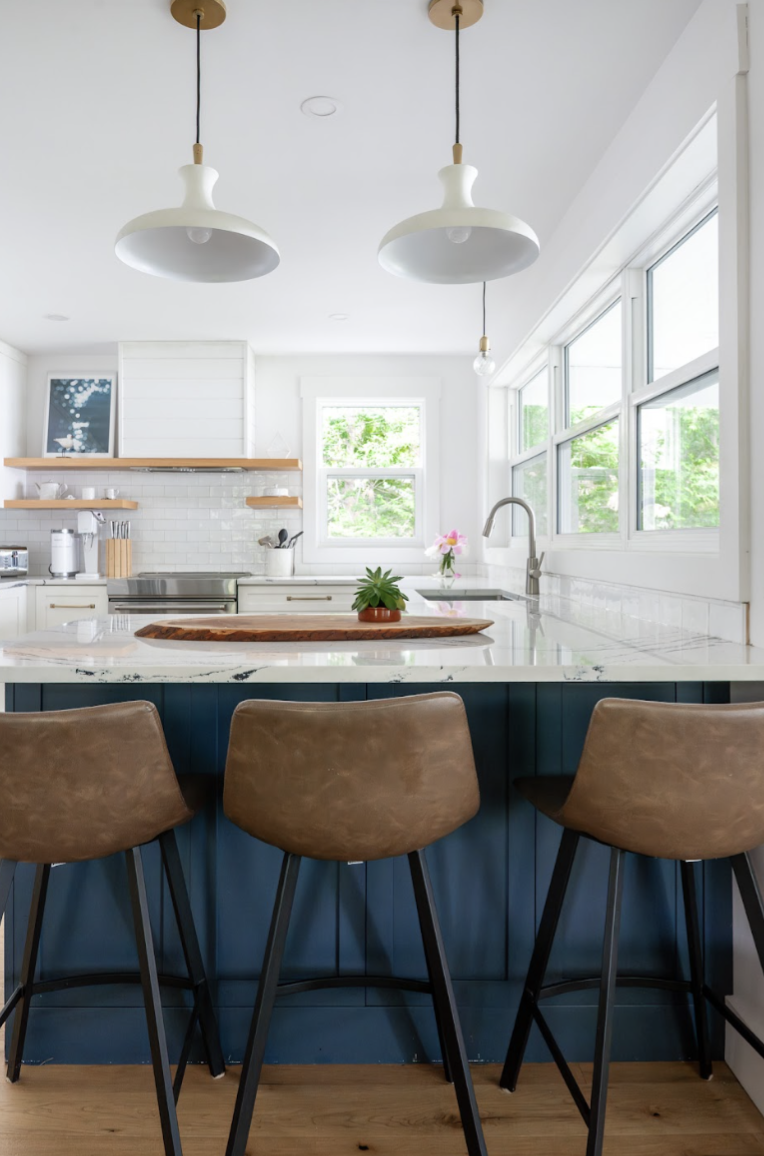 This cottage kitchen counter peninsula utilizes two hanging lights characteristic of the cottage era style. They add both detail and function.