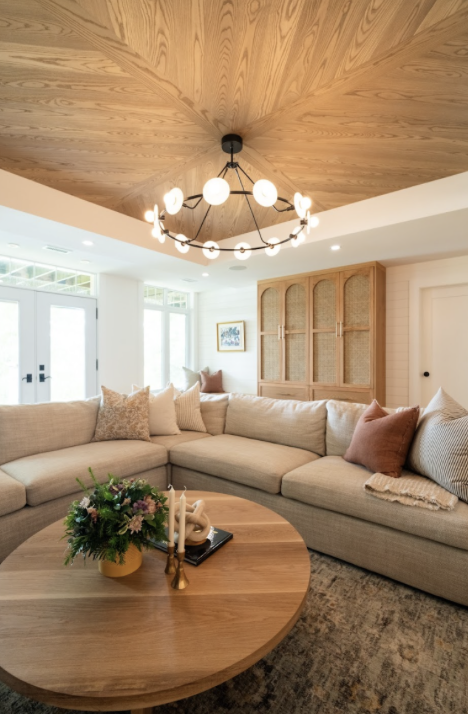 A focal point chandelier pays off the coffered wood ceiling and brings a wow factor to this lower level.