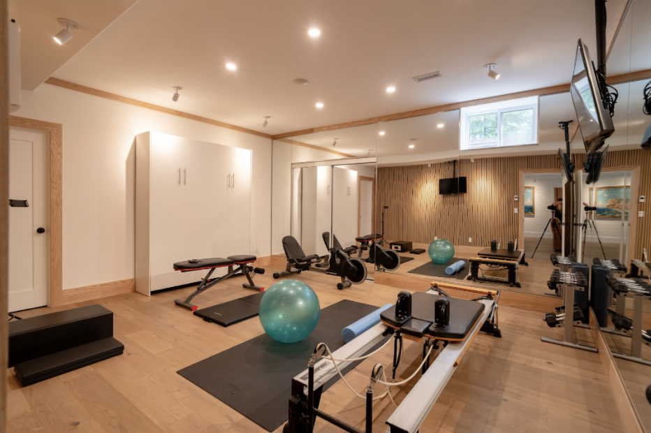 In our client’s home gym, we used recessed lighting and wall mounts to accent the TV wall and the storage cabinet. Lighting allows an otherwise dark and forgotten space to become a useful and warm area.