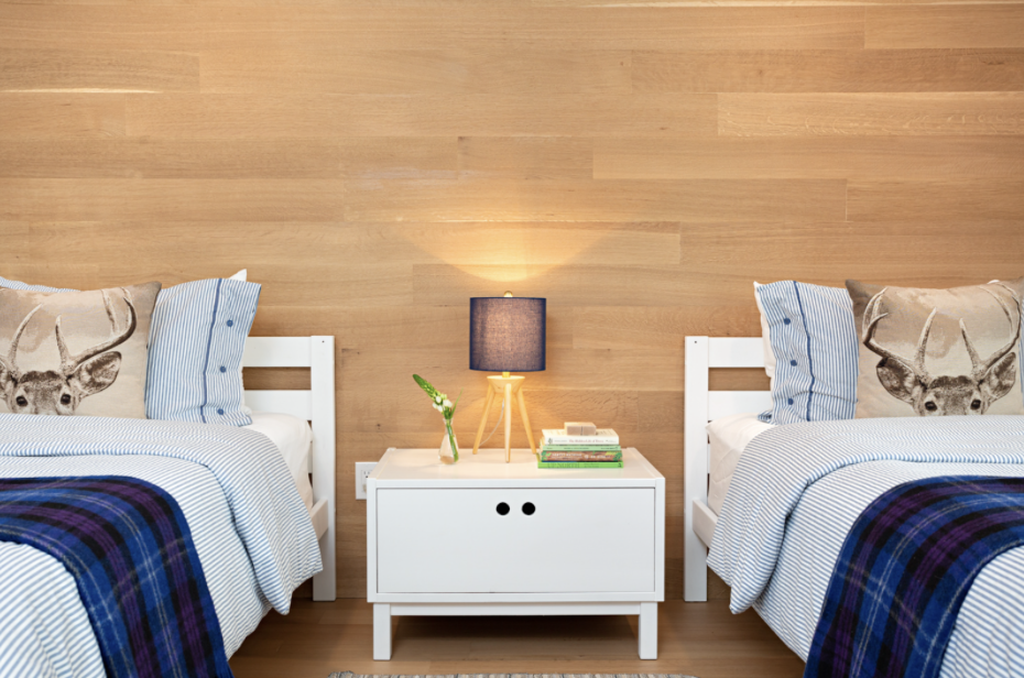   A warm wood wall and wool blankets help warm this guest room in our Gull Lake project.  