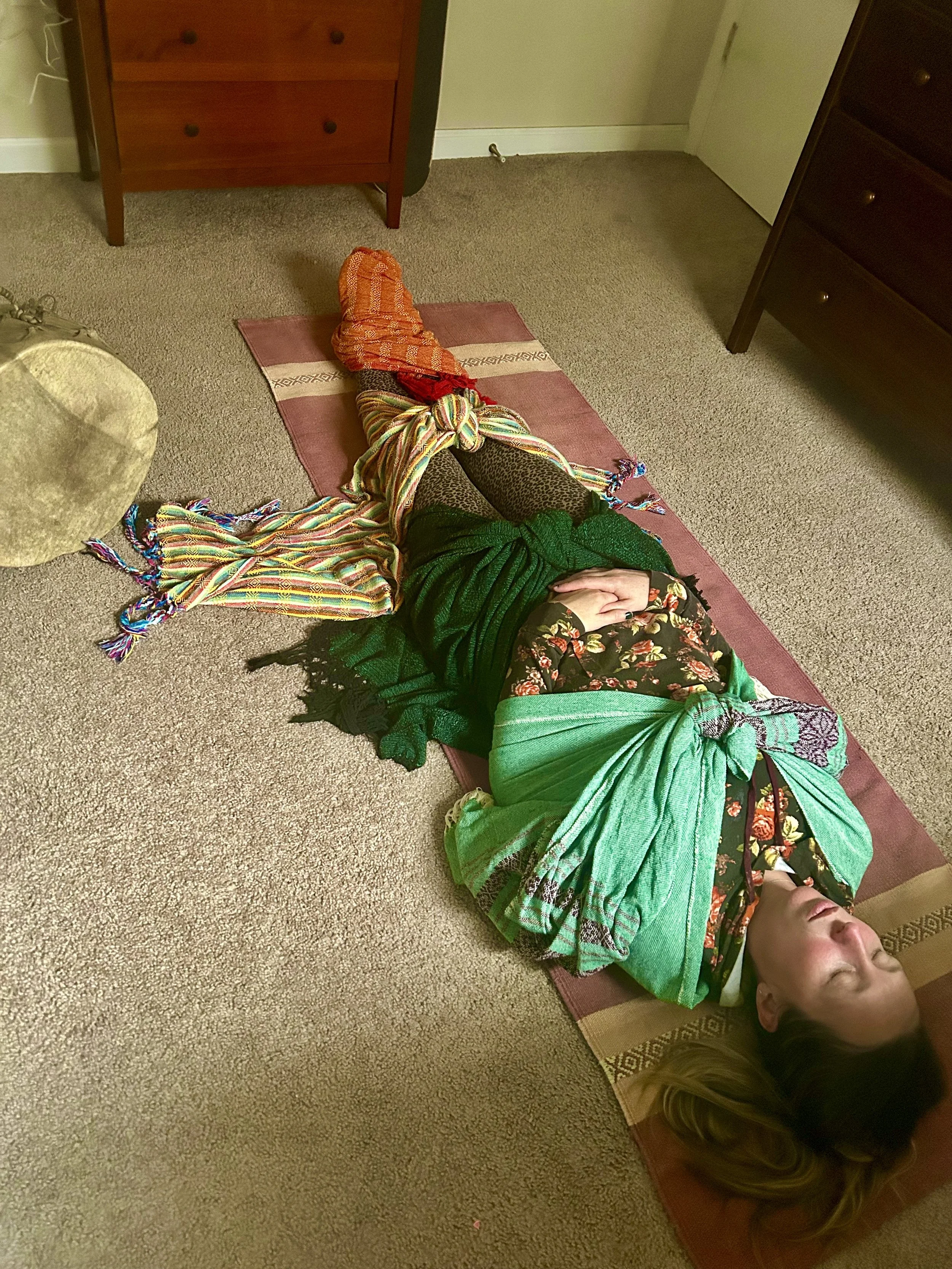 a client wrapped in rebozos in closing of the bones ceremony in Boulder, Colorado