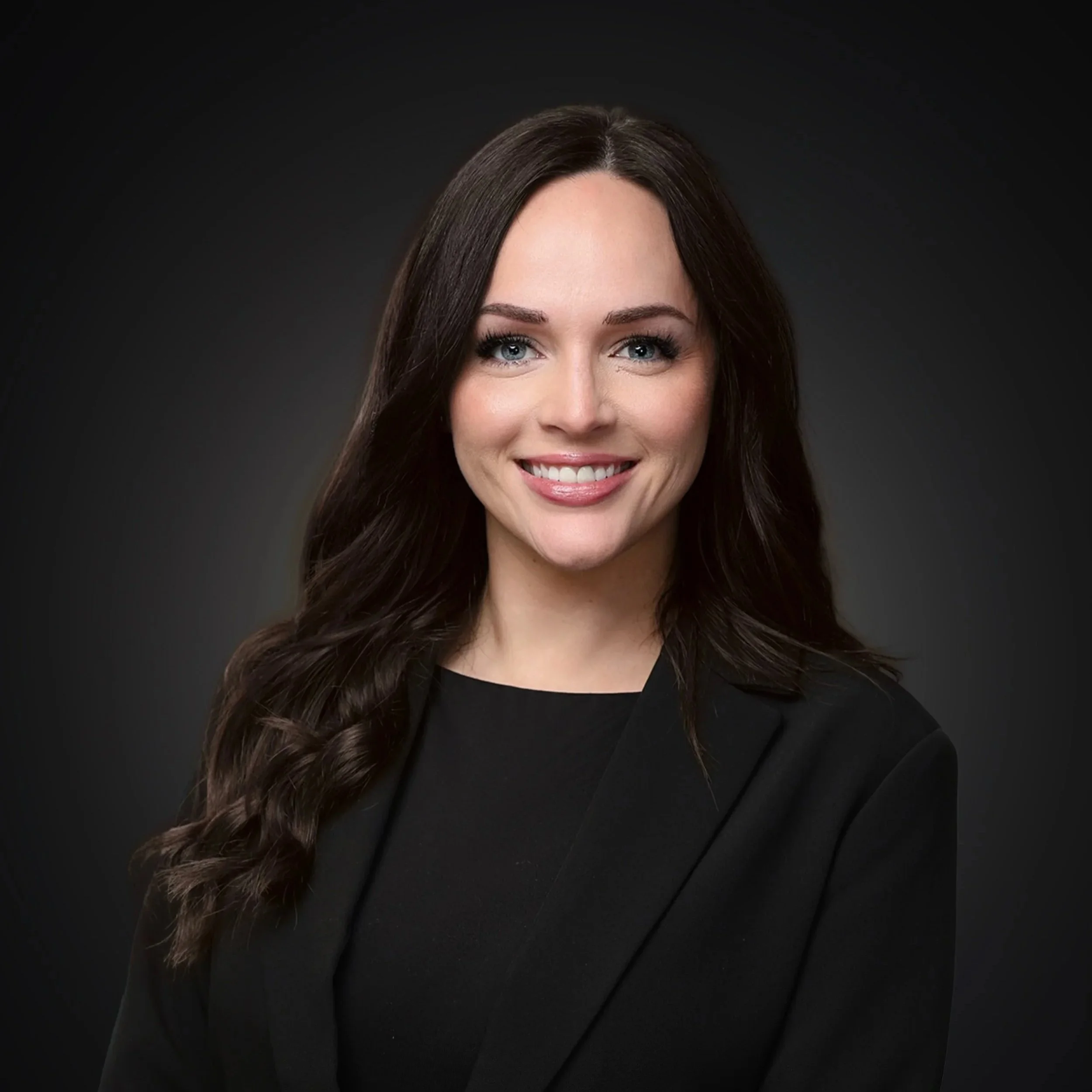 Portrait of a woman with shoulder-length dark brown hair, blue eyes, light makeup I Scott Brown Properties I Denton, TX 