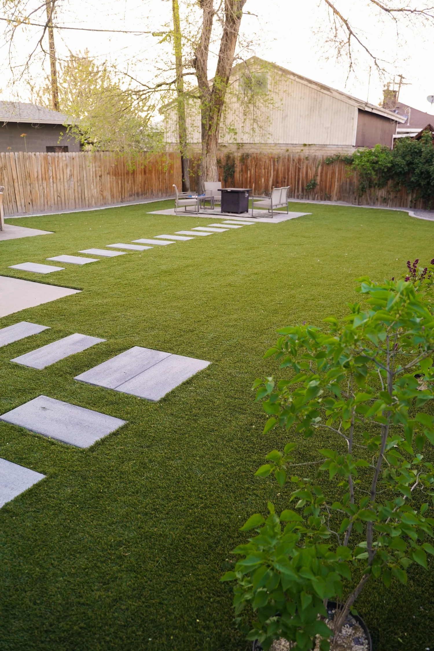 Backyard turf with a stepping-stone path and landscaping