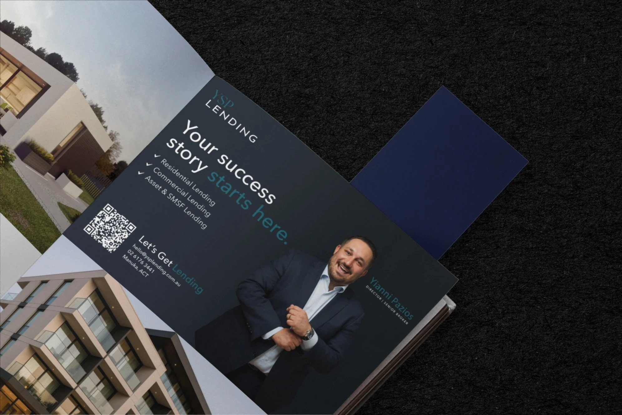 A printed real estate brochure featuring a modern apartment building with balconies and large windows, alongside a portrait of a smiling man in a navy suit, white shirt, and blue tie. The brochure includes text about home and commercial lending servi