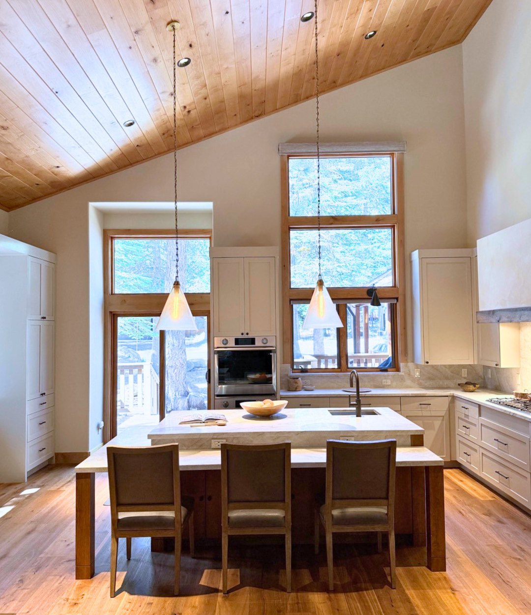 custom modern kitchen with big windows and tall ceilings and center island sink