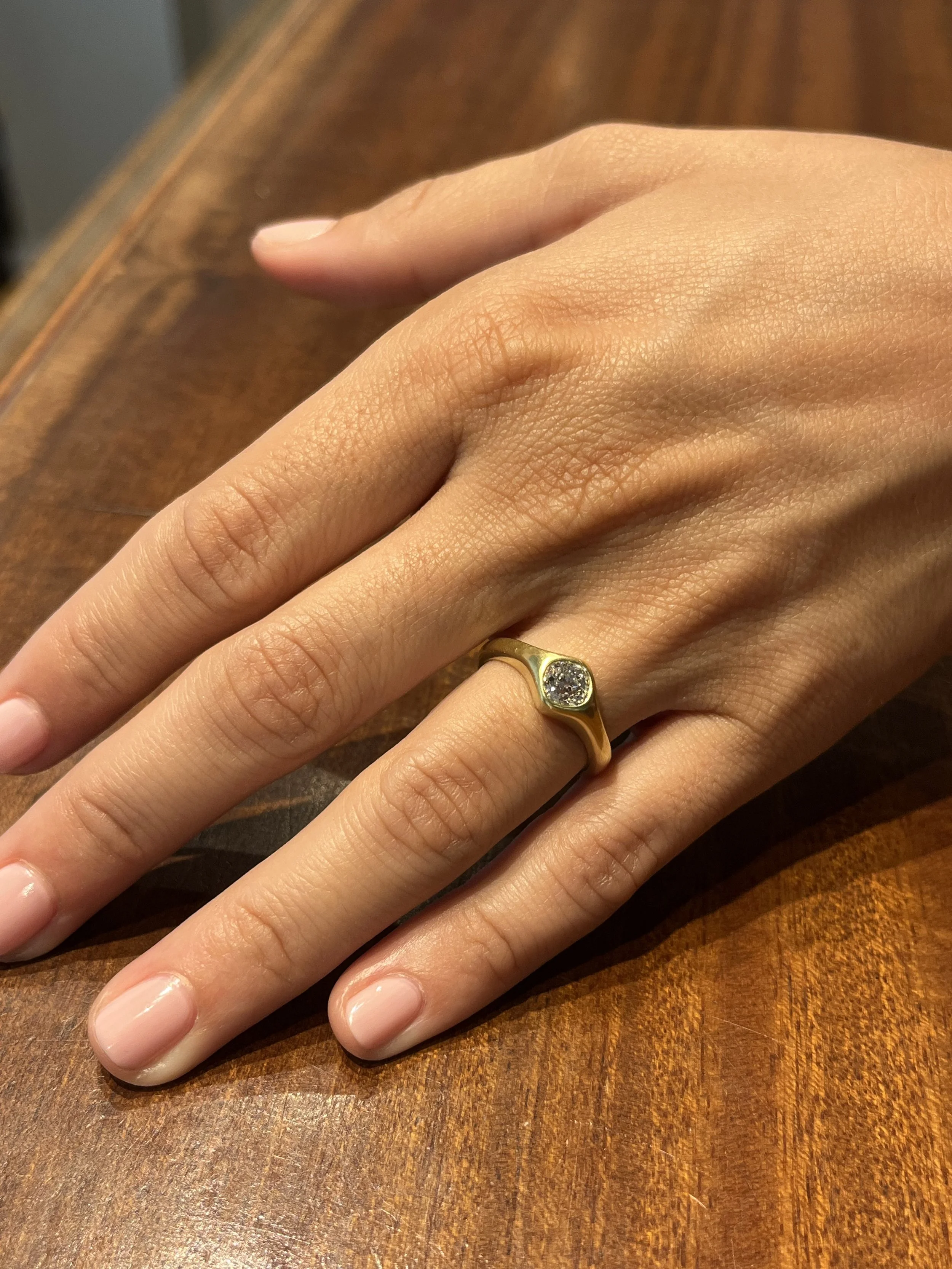 antique old mine cut diamond engagement ring on hand