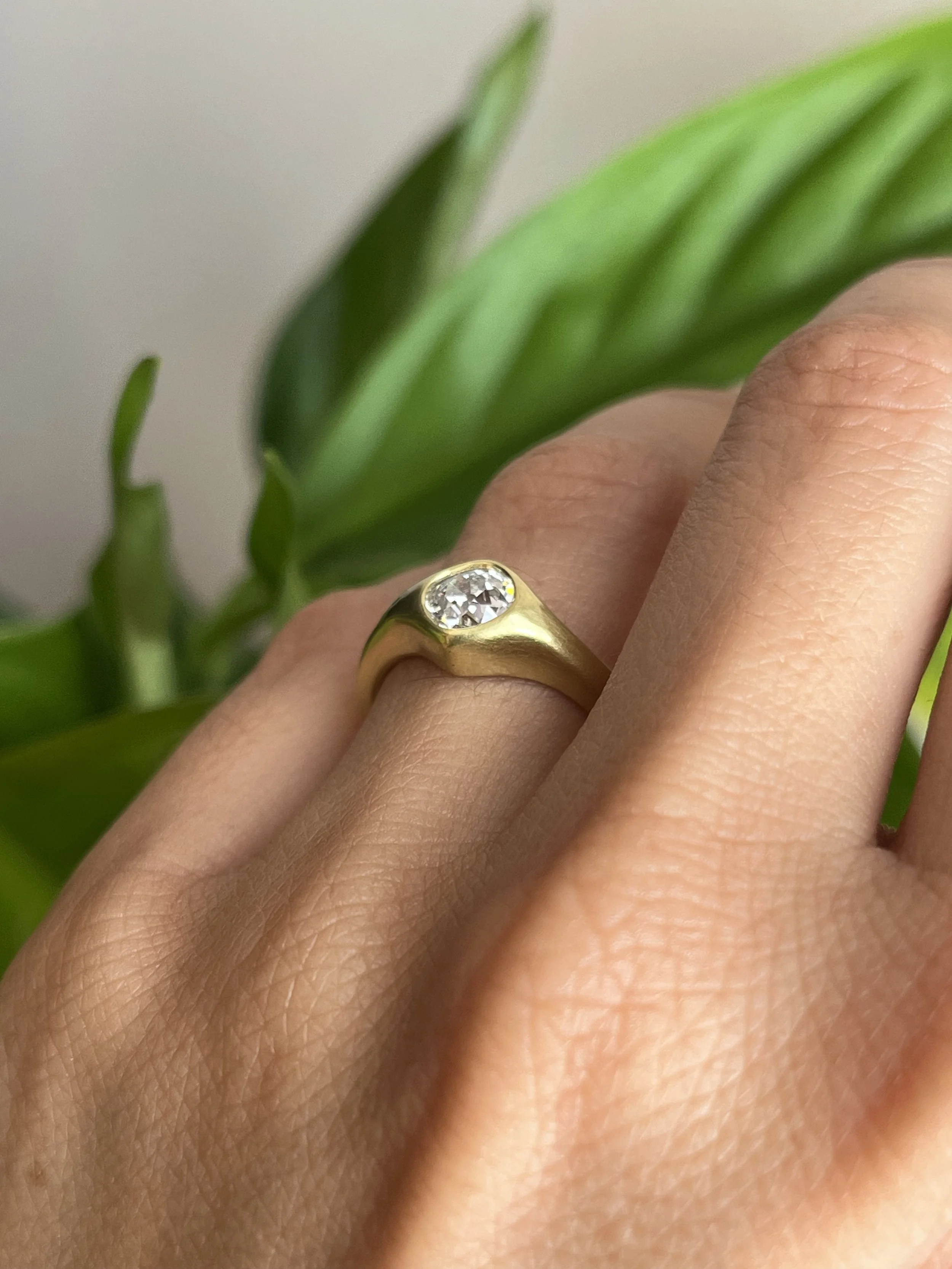 antique old mine cut diamond engagement ring on hand