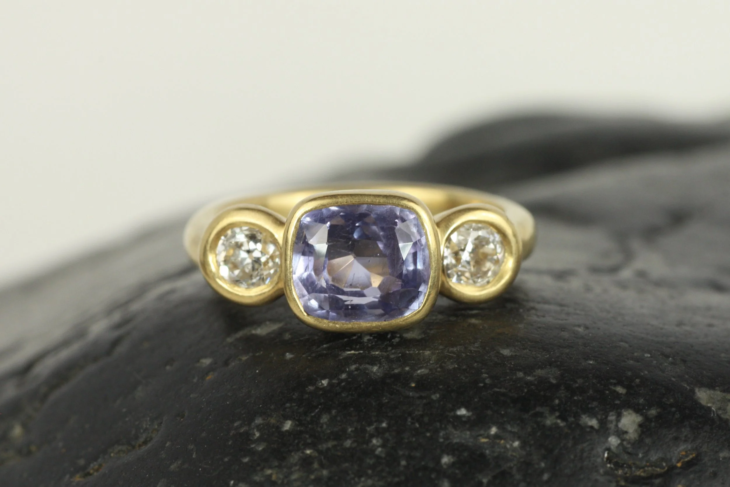 Purple Sapphire and Diamond Three-Stone Bezel Ring