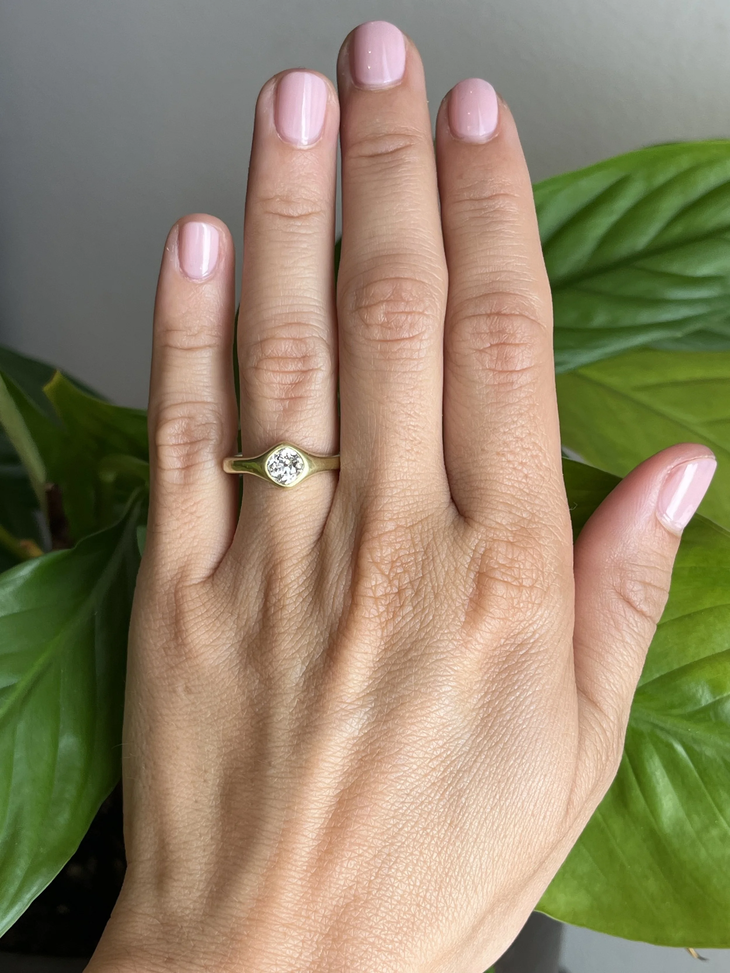 antique old mine cut diamond engagement ring on hand