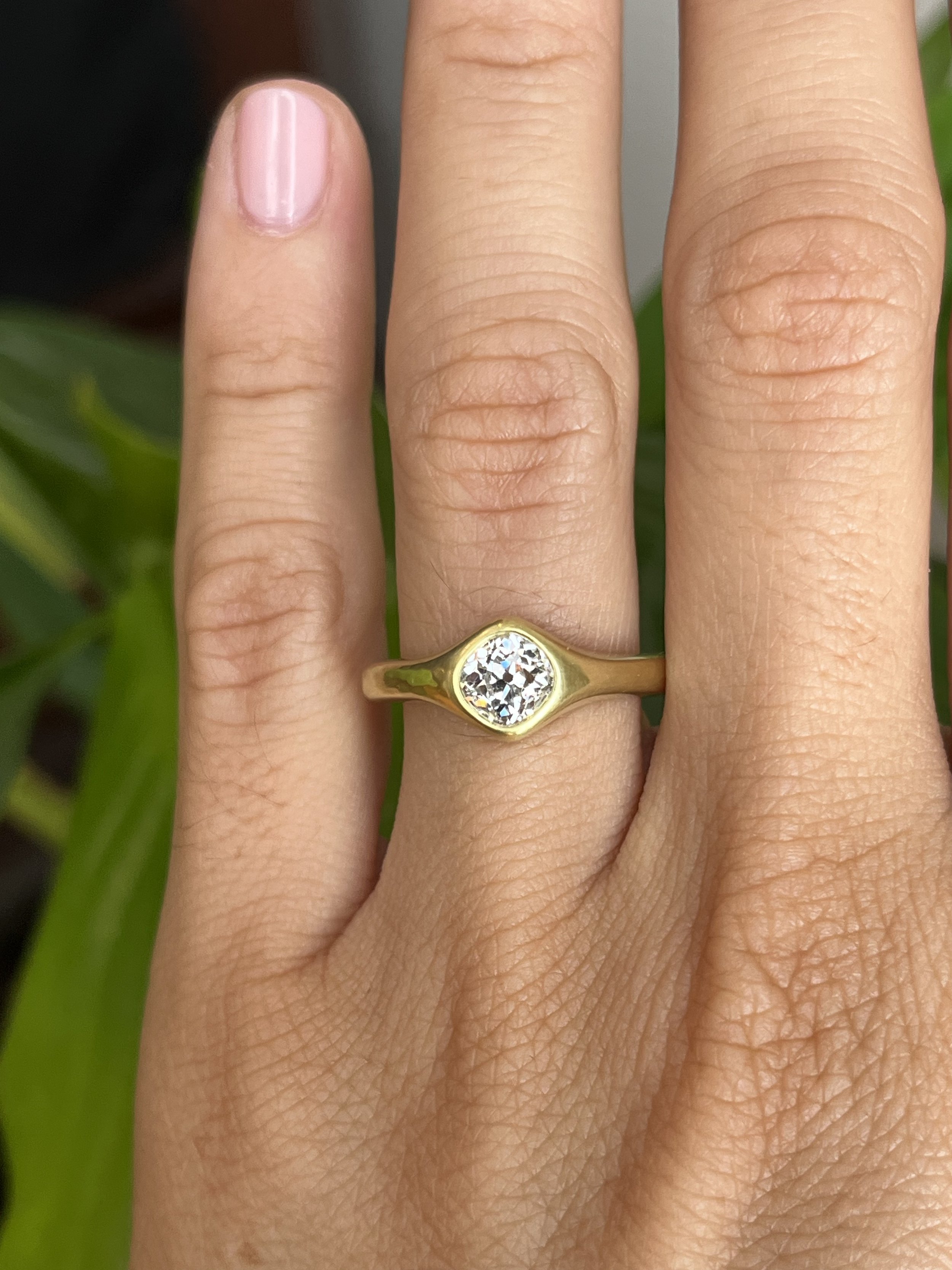 antique old mine cut diamond engagement ring on hand