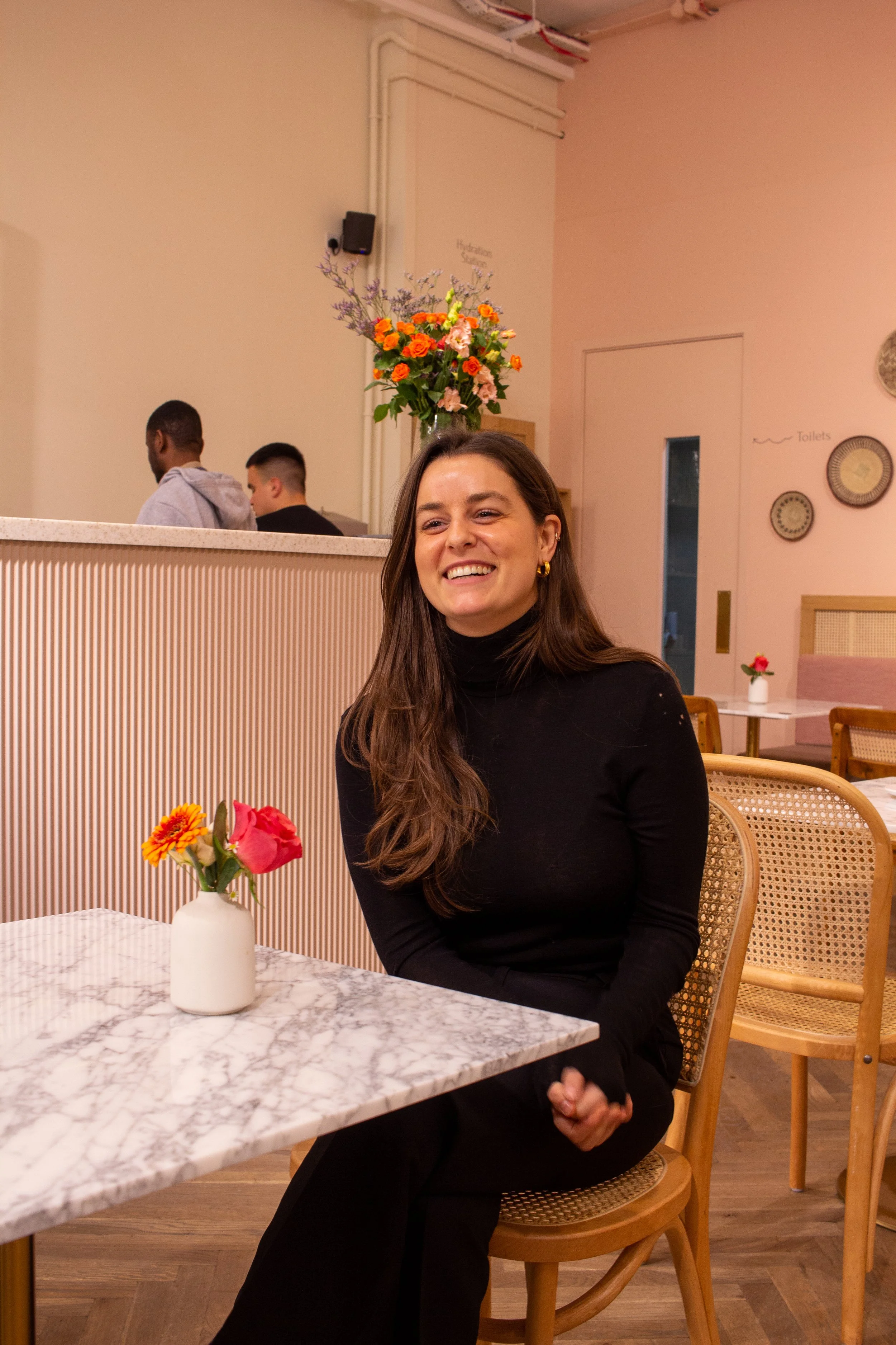 Bianca Tavella ceo smiling young woman laughing inside cafe Covent Garden