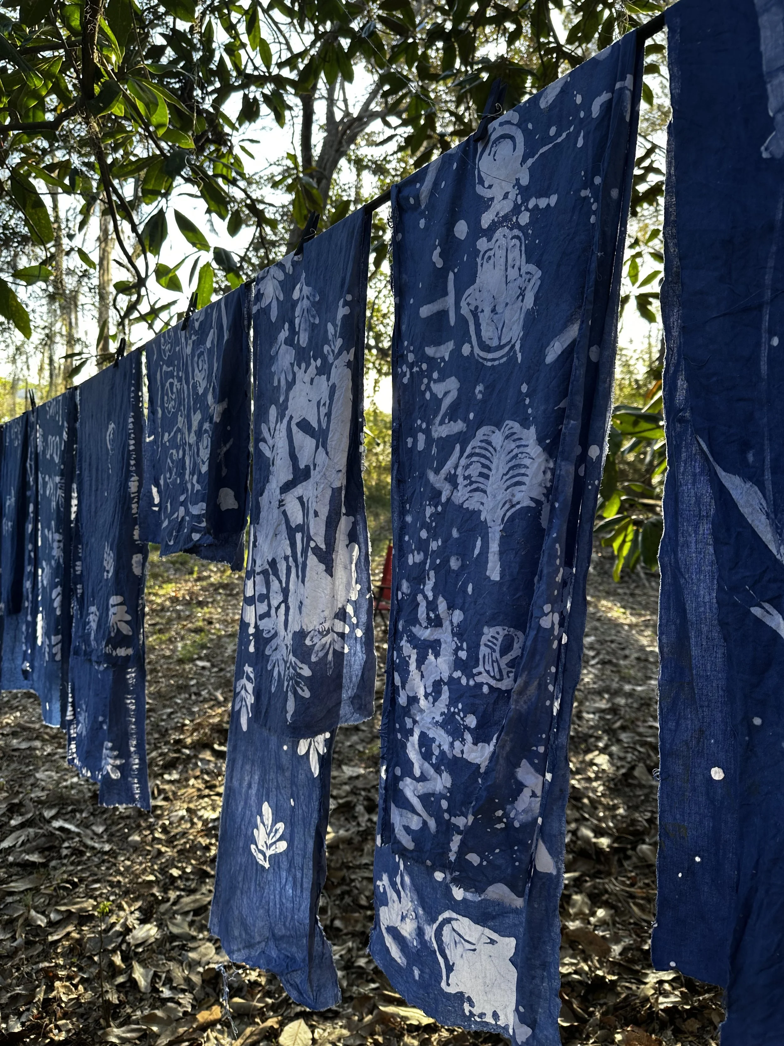 Indigo being hung to dry with patterns displayed across cloth