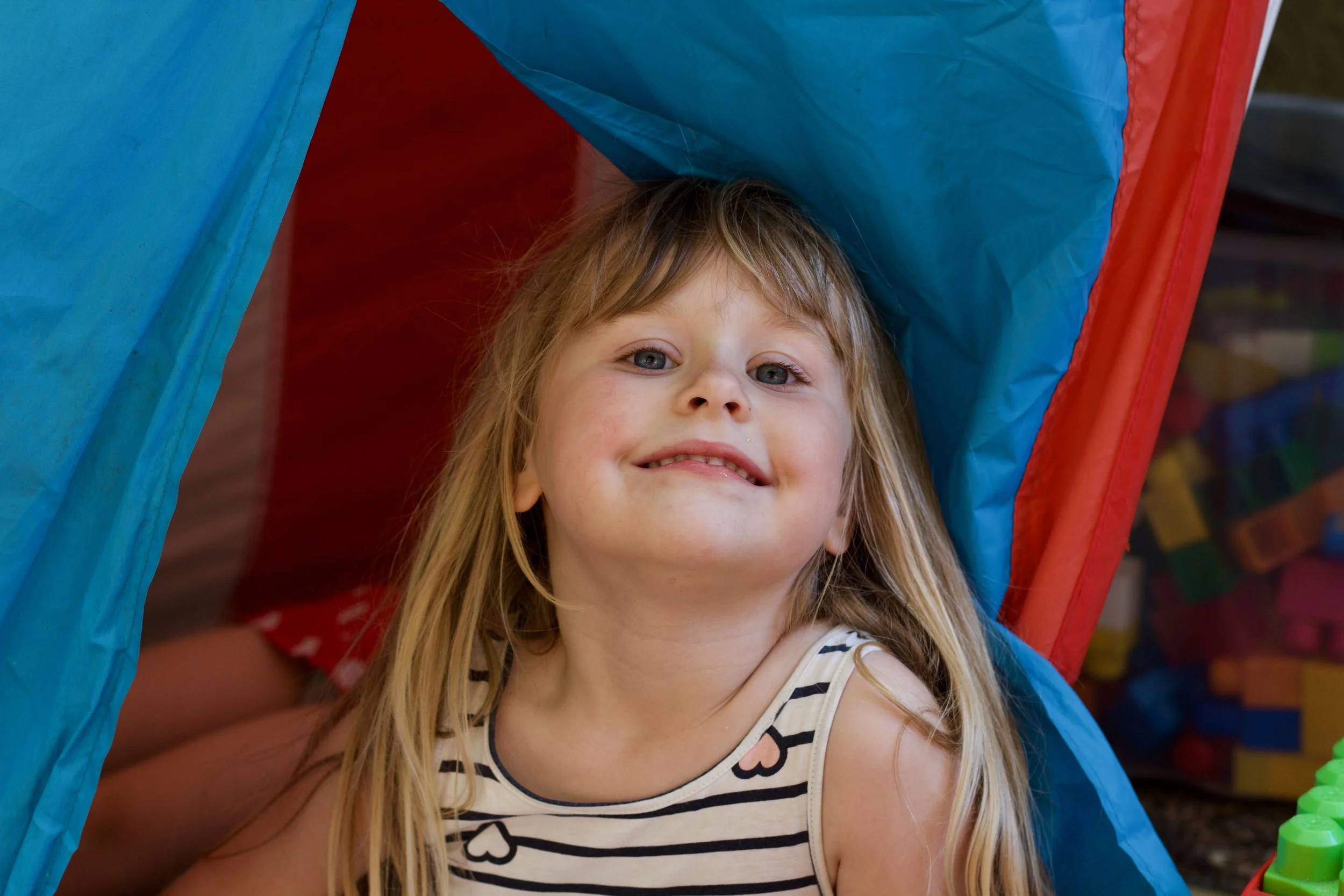 young girl smiling in tent.JPG