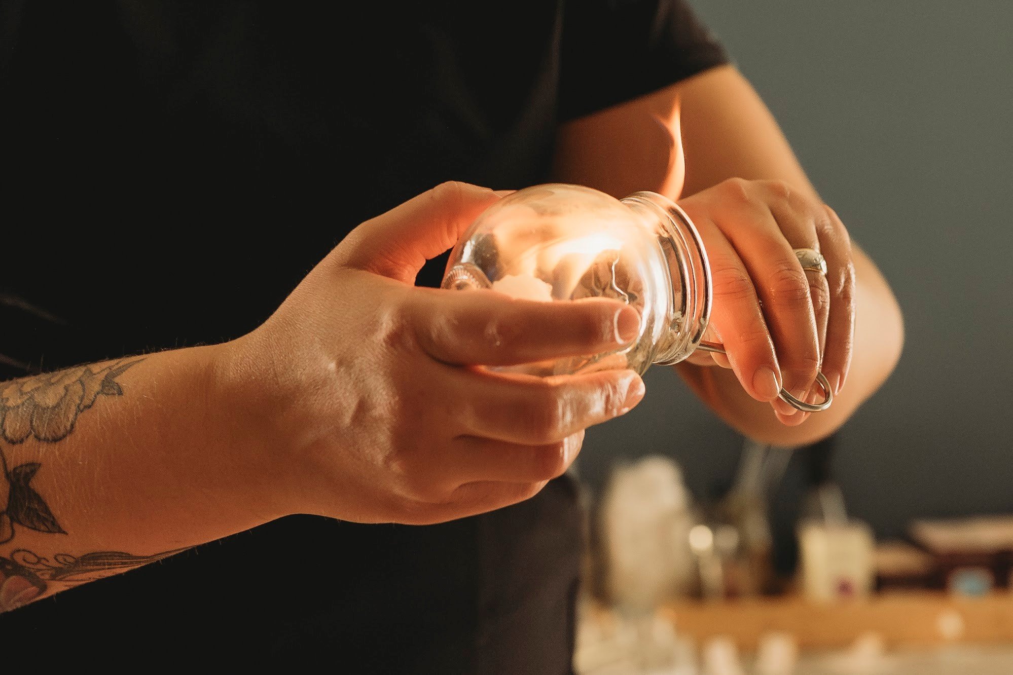 acupuncturist in Corning NY lighting a flame to a traditional glass fire cupping cup