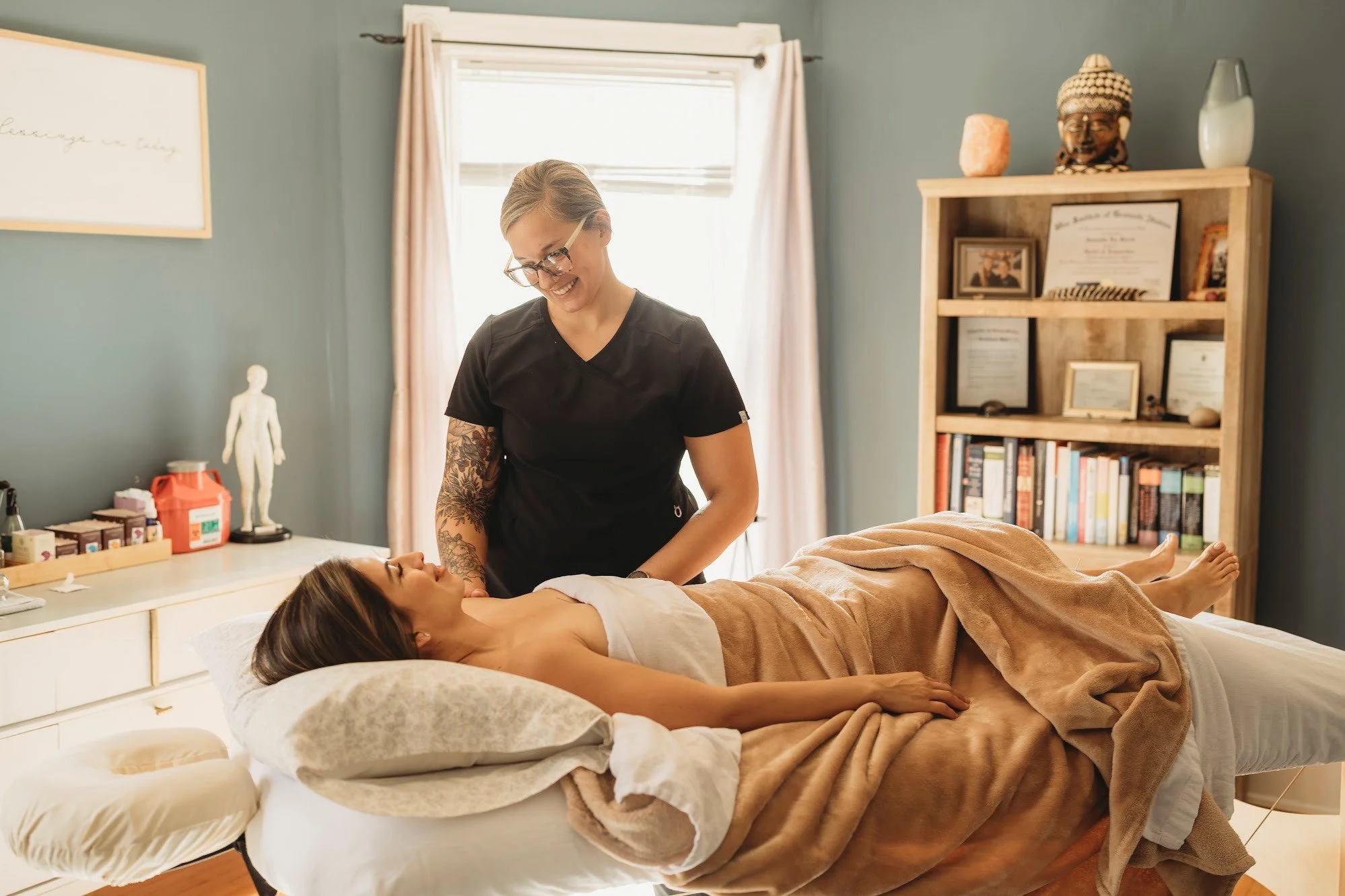 Dr. Samantha Burris caring for an acupuncture patient at Essence Healing Acupuncture located in Corning New York