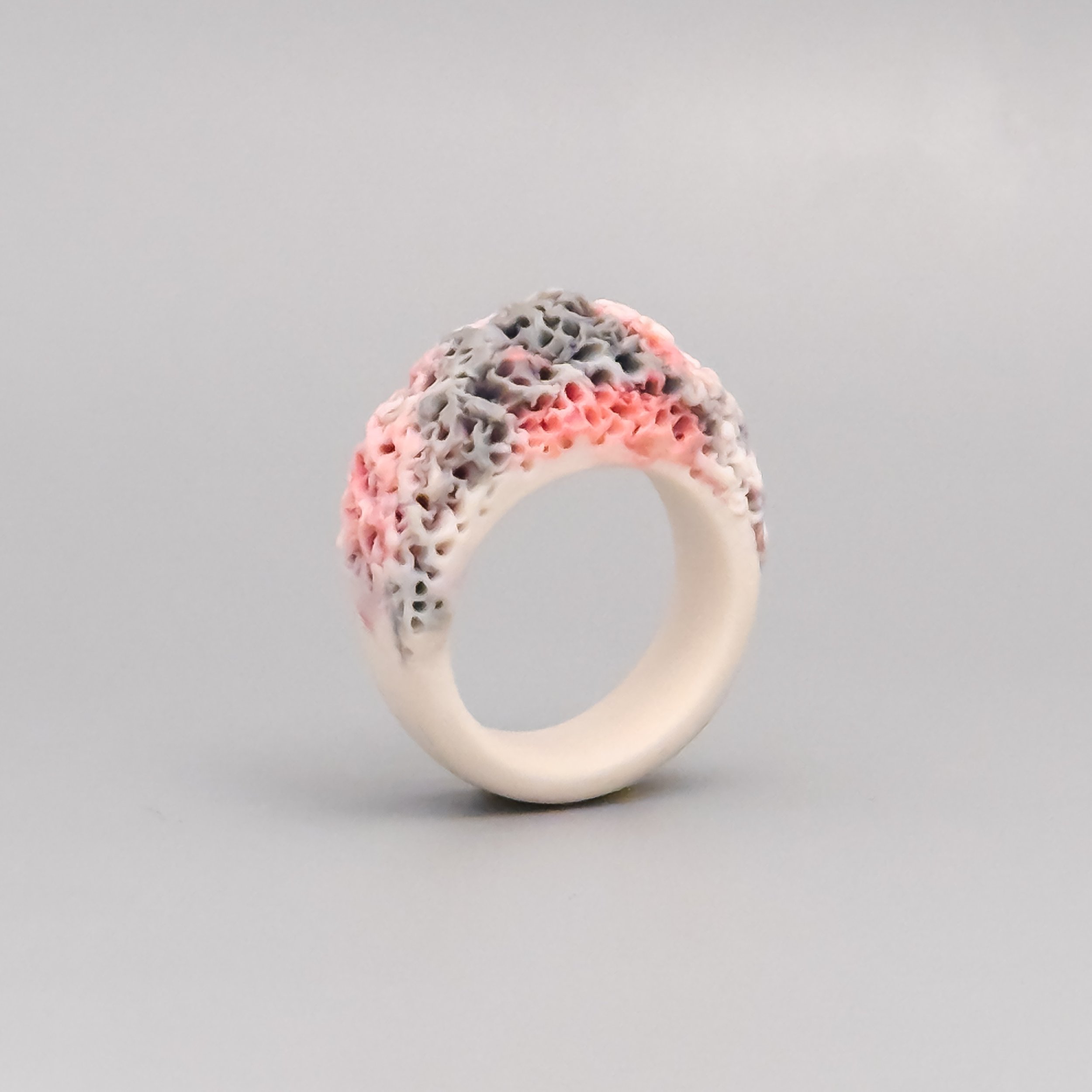 Sculptural unglazed porcelain ring with mixed pink and gray clay crown – eco-conscious coral reef inspired design