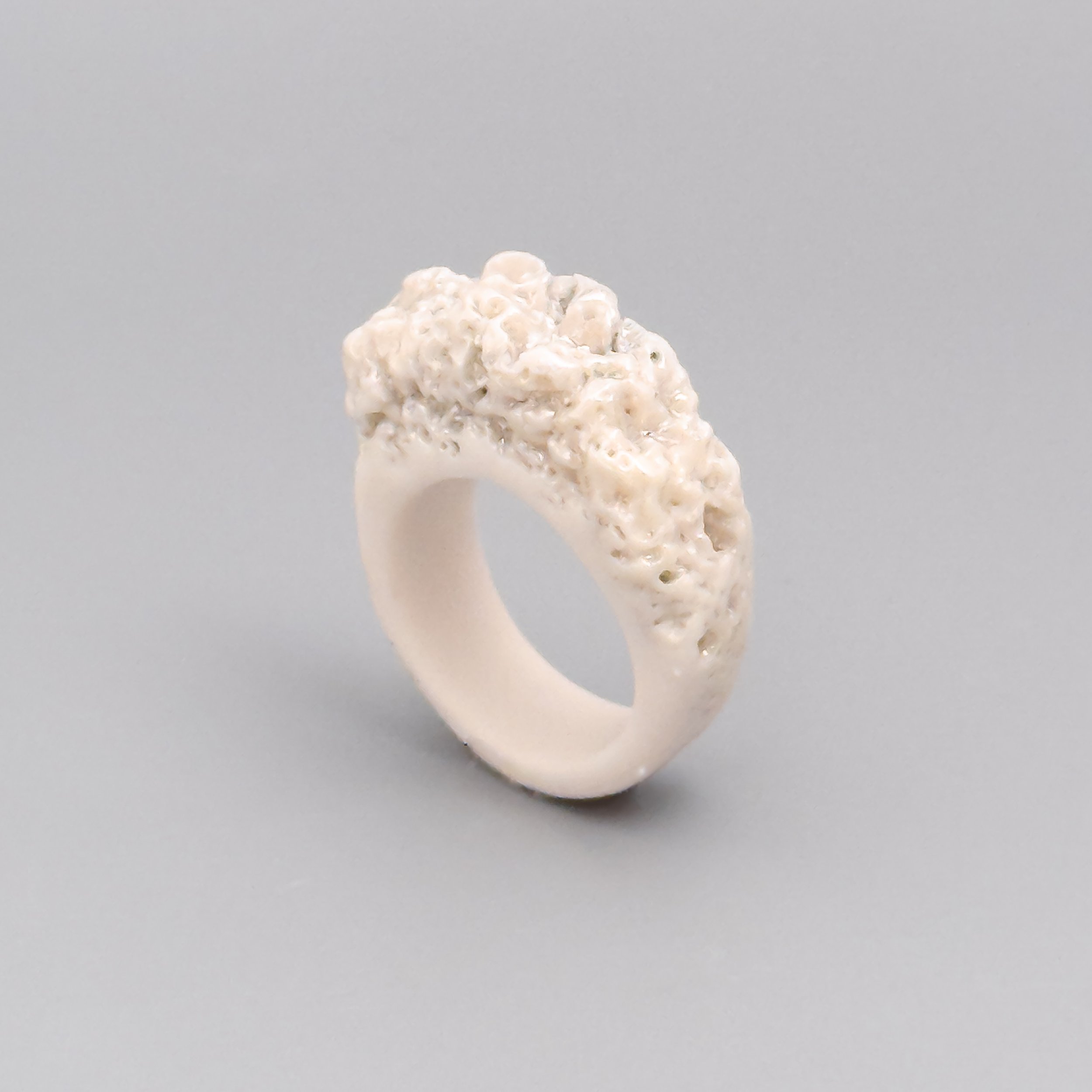 Porcelain ring handmade in Brooklyn with sculpted coral texture and iridescent mother-of-pearl luster – white ceramic jewelry by Argilla NYC