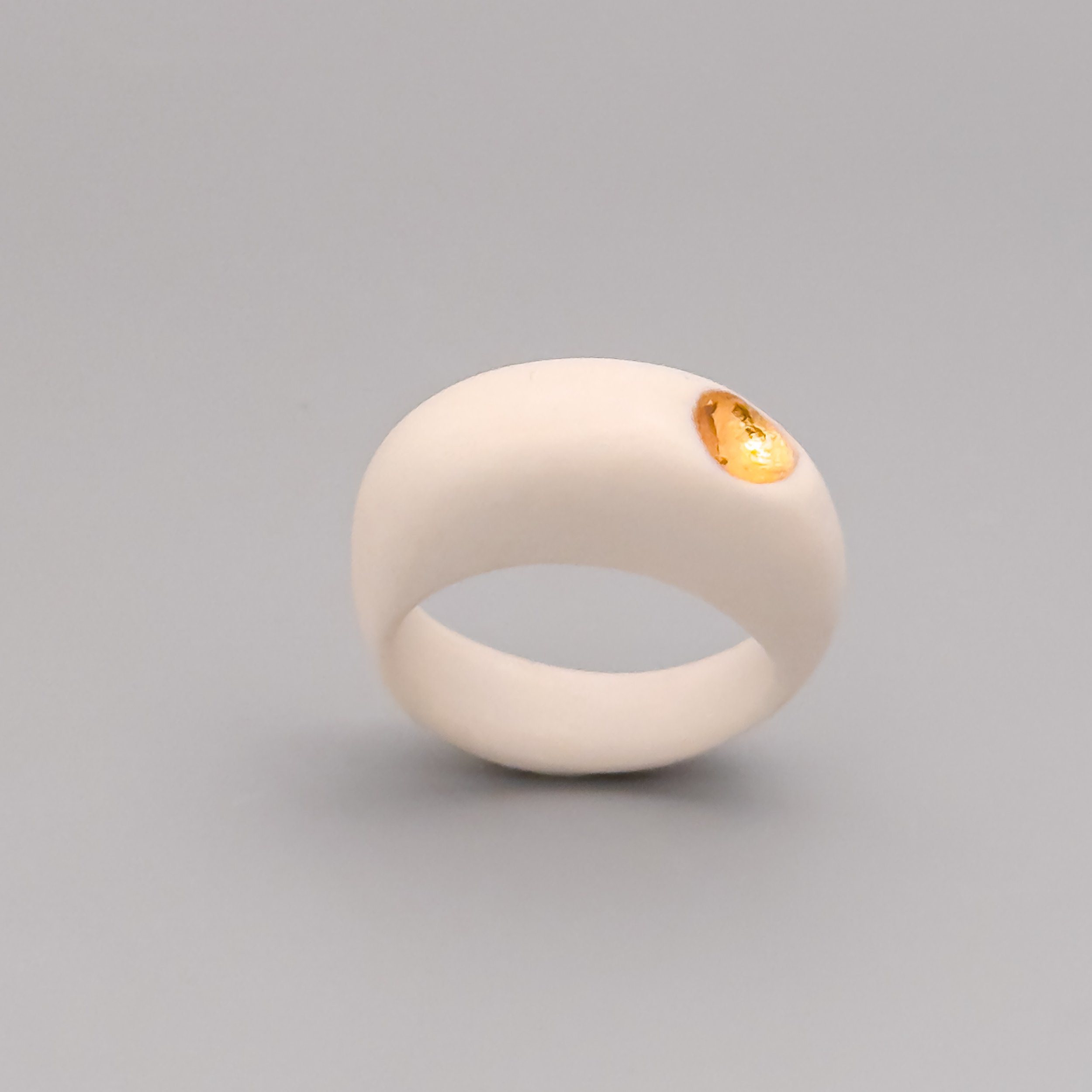 culptural porcelain ring showing the asymmetrical lustered void