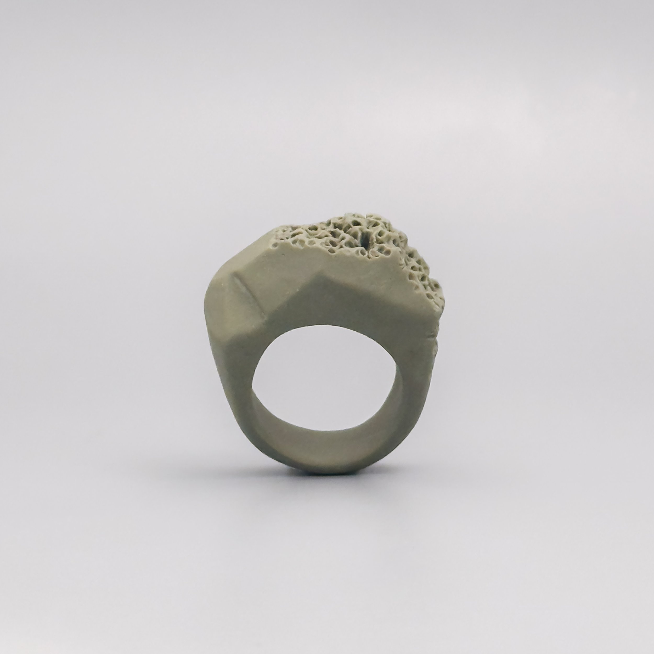 Porcelain ring in soft neutral tones with coral reef–inspired crown and sculptural matte finish