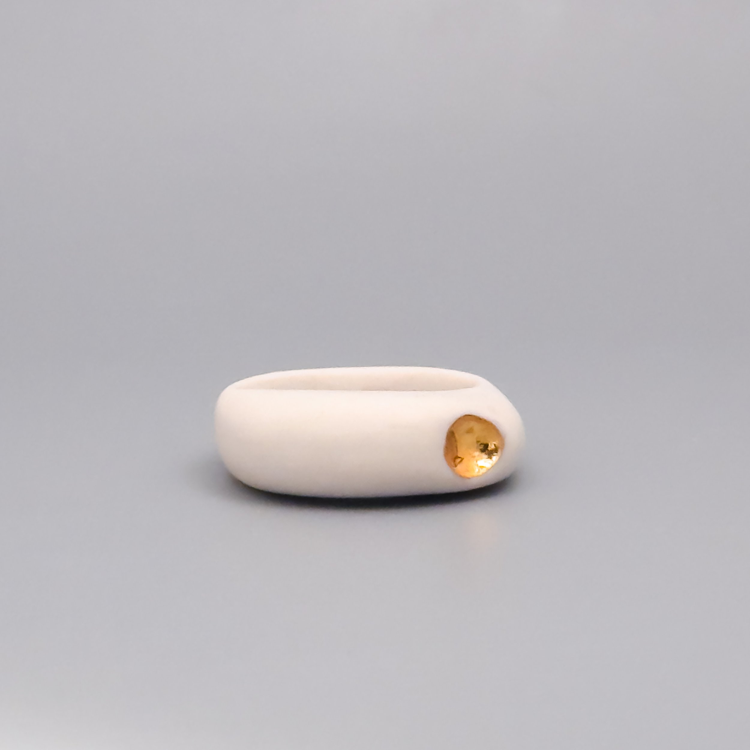 Handmade ceramic ring in white porcelain with matte finish and gold metallic detail