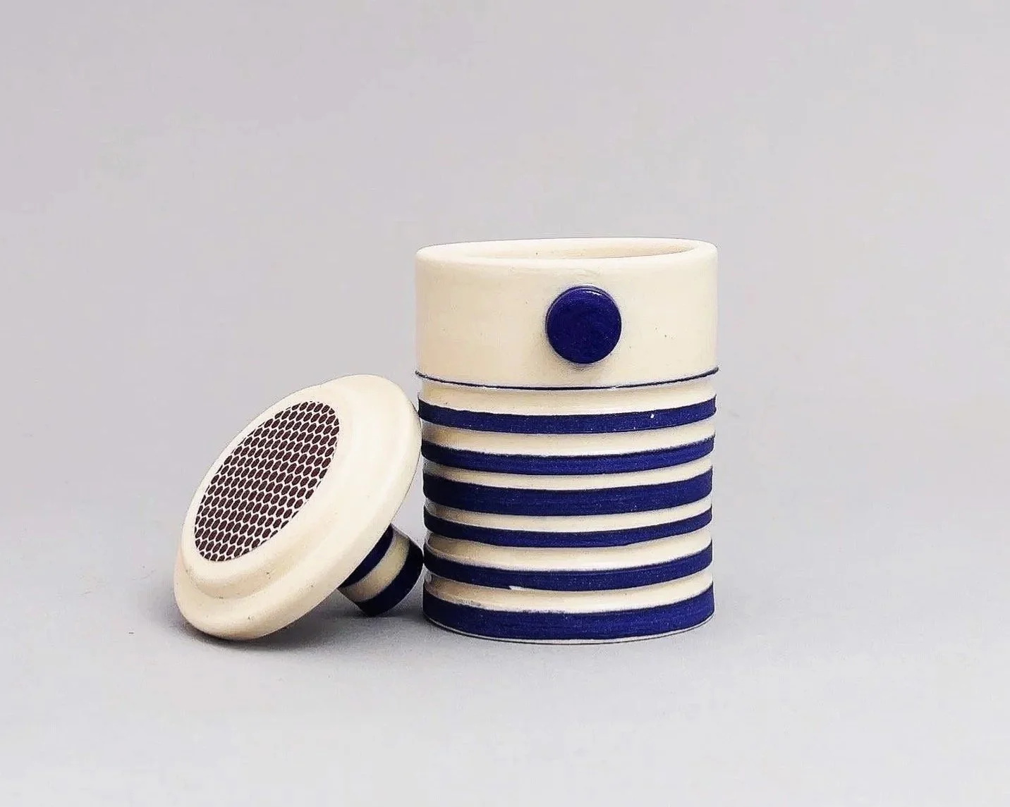 Handmade ceramic match striker with mazarine blue carved stripes and clay dot, Argilla NYC Brooklyn studio.