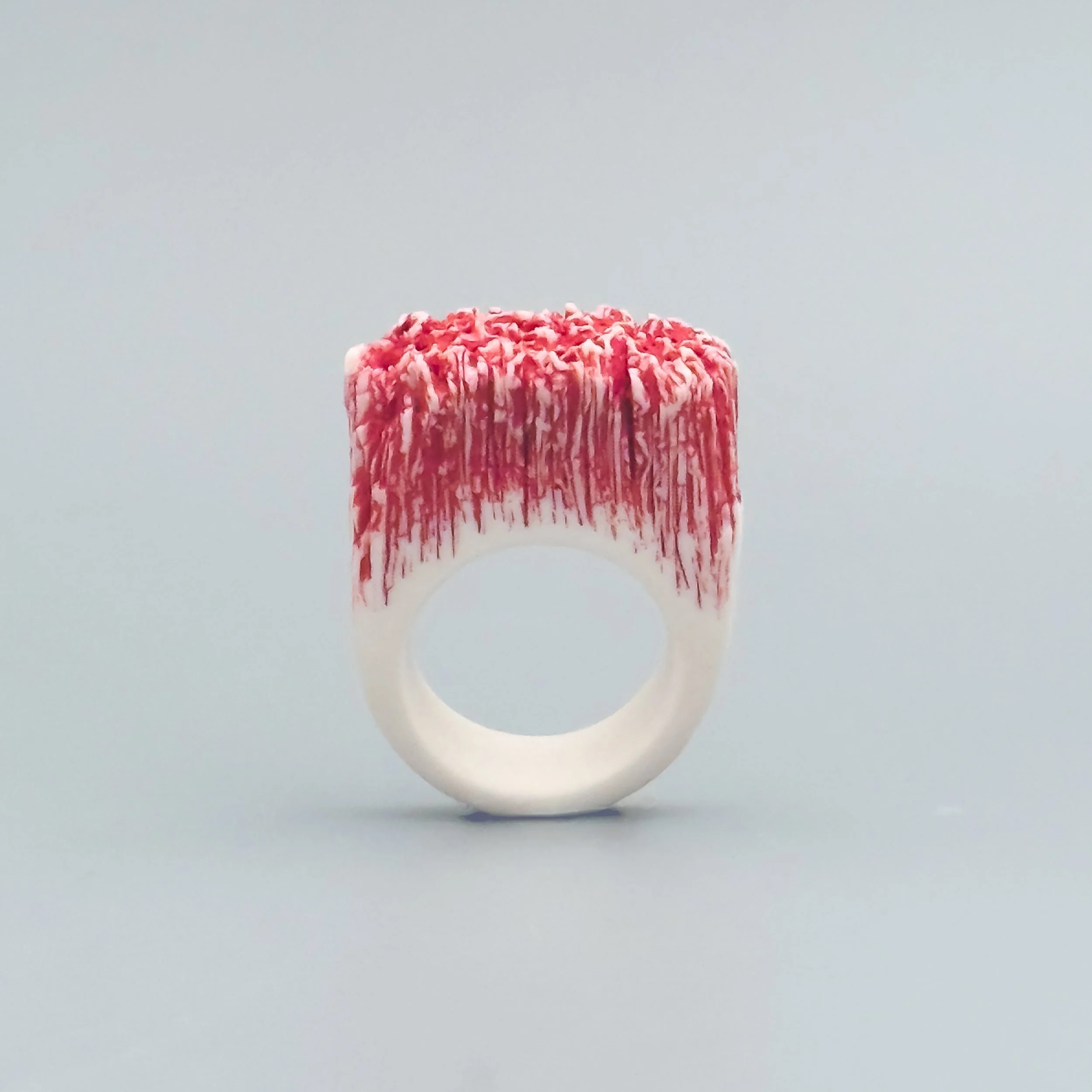 White porcelain ring with red coral-inspired crown