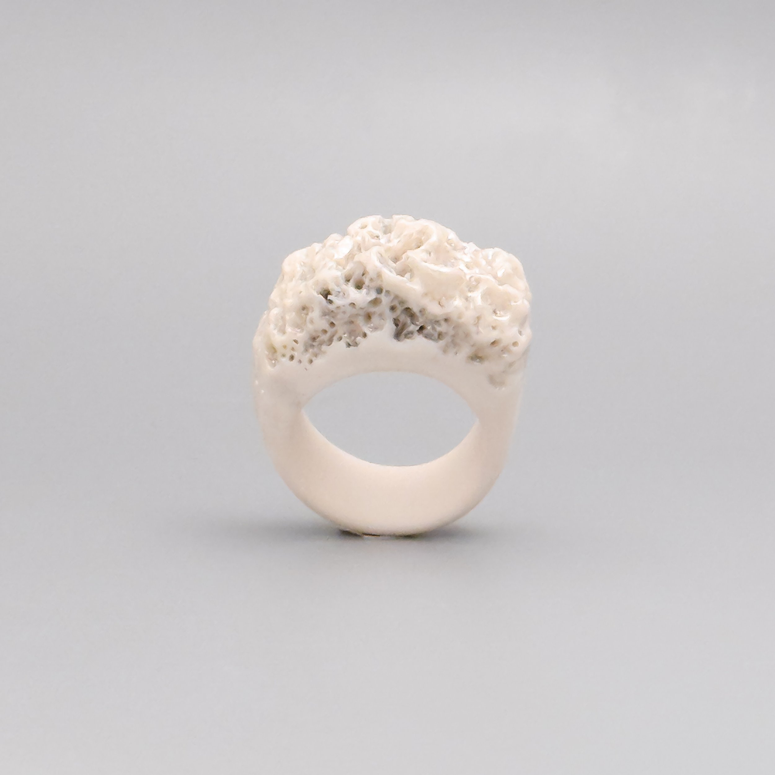 Sculptural porcelain ring in Limoges clay with textured reef-inspired crown and pearlescent luster – artisan ceramic jewelry
